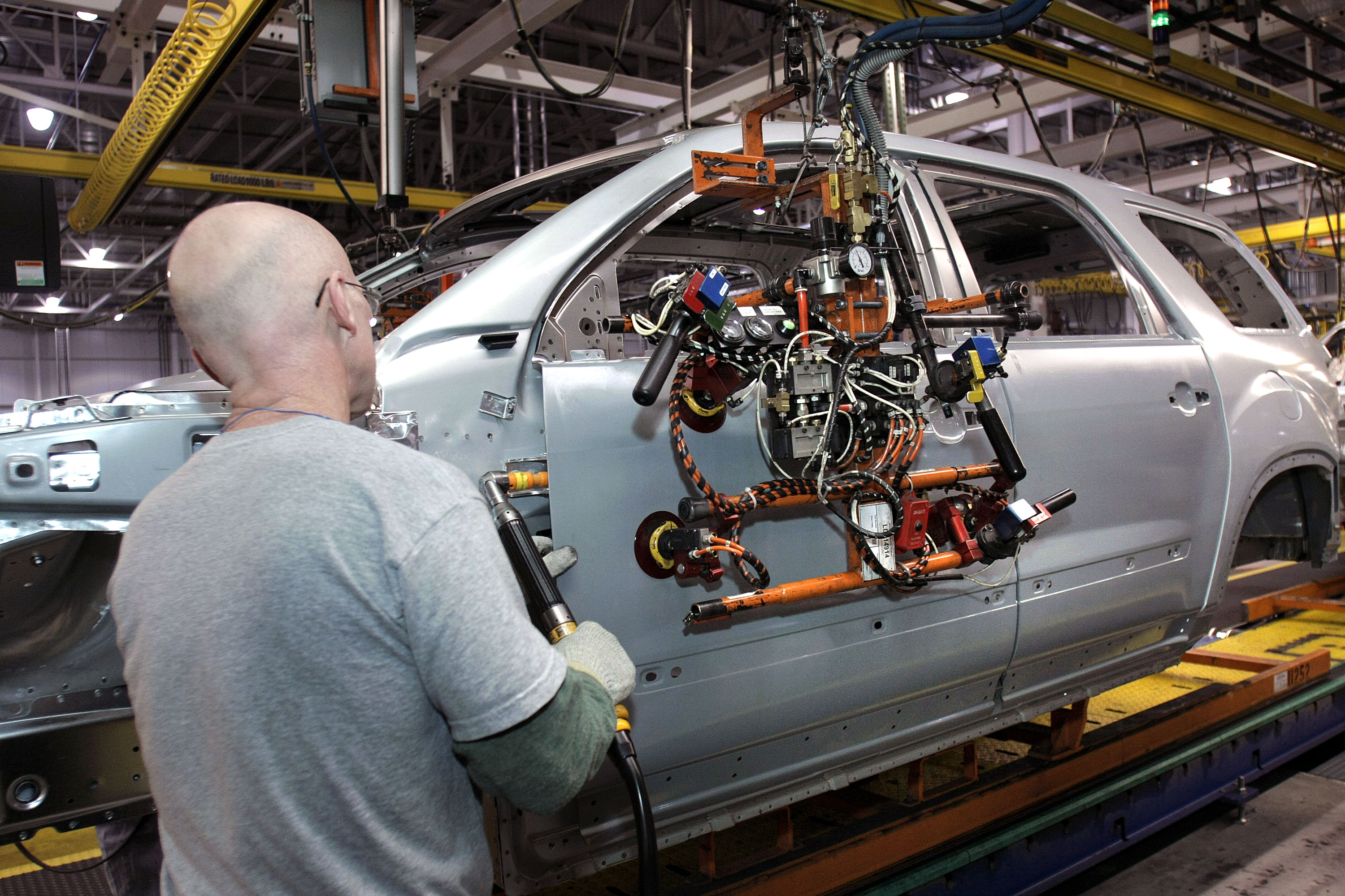 General Motors employees assemble a GM crossover SUV on the assembly line at the GM Lansing Delta Township Assembly Plant in Lansing, Michigan.
