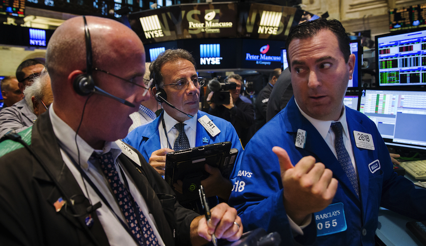 Traders on the floor of the New York Stock Exchange shortly after the opening bell in New York Wednesday
