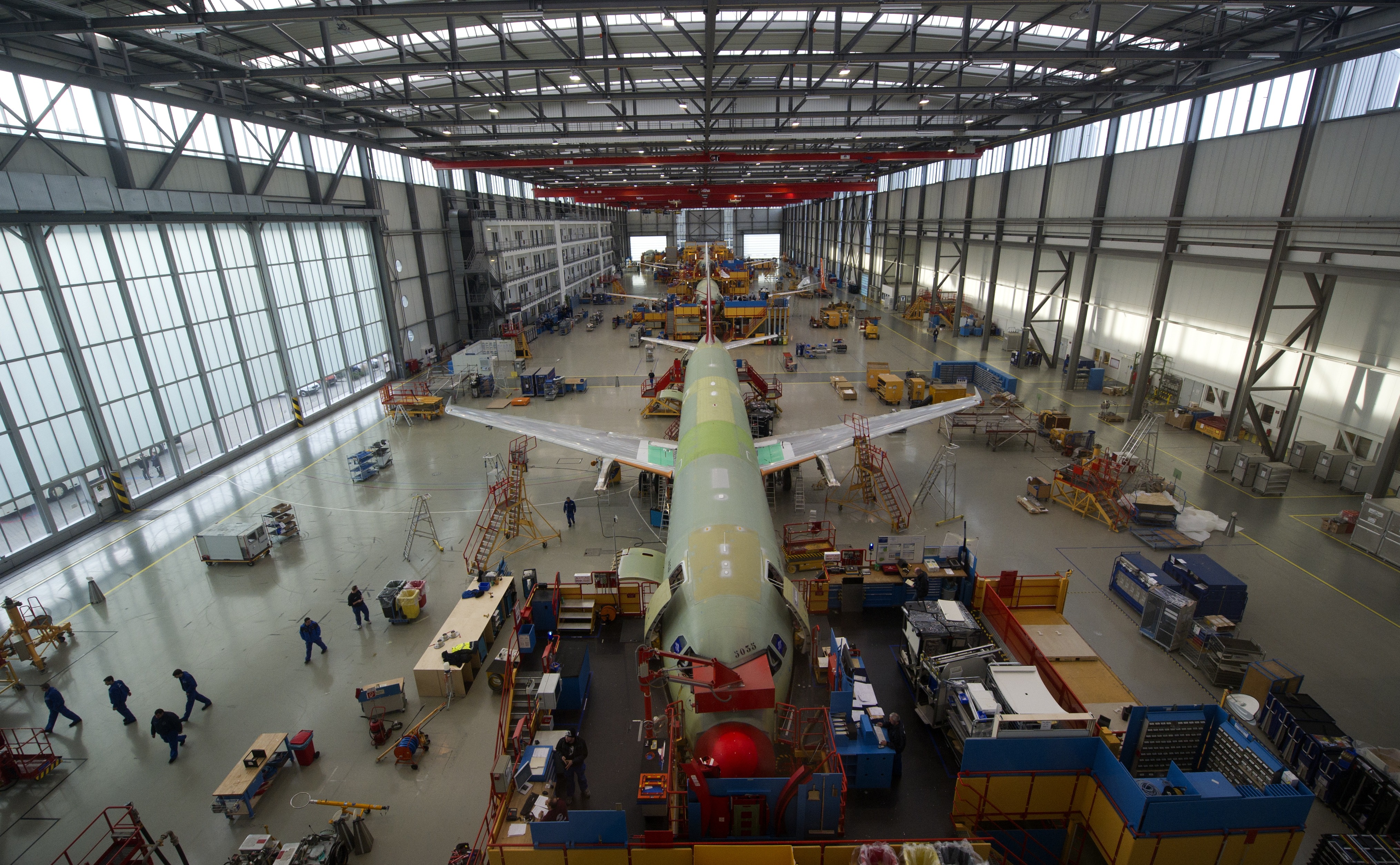 Employees of aircraft manufacturer Airbus work on an Airbus A320 plane under construction at a production hall of Airbus in Hamburg, northern Germany. A new Airbus factory has been unveiled in Alabama, setting itself up for a fierce fight with Chicago-based Boeing.