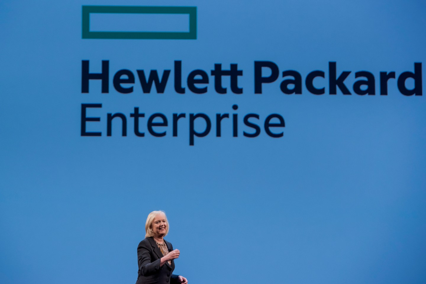 Meg Whitman, chief executive officer of Hewlett-Packard Co., speaks with the new Hewlett Packard Enterprise logo on the screen, during the HP Discover 2015 conference in Las Vegas, Nevada, U.S., on Tuesday, June 2, 2015. Hewlett-Packard Co. reported fiscal second-quarter profit that exceeded analysts' estimates as corporate spending on servers picked up ahead of the computer maker's planned separation into two companies. Photographer: David Paul Morris *** Local Caption *** Meg Whitman