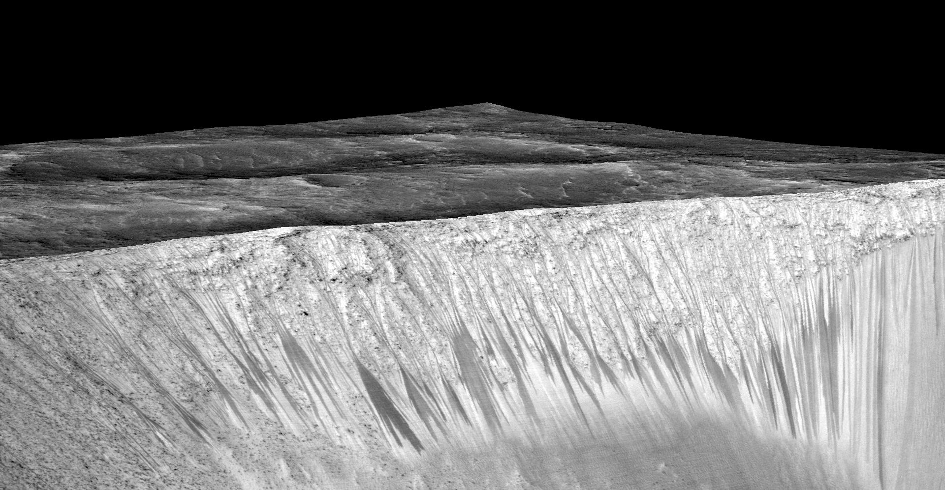 The dark, narrow streaks flowing downhill on Mars at sites such as this portion of Horowitz Crater are inferred to be formed by seasonal flow of water on modern-day Mars. The streaks are roughly the length of a football field.