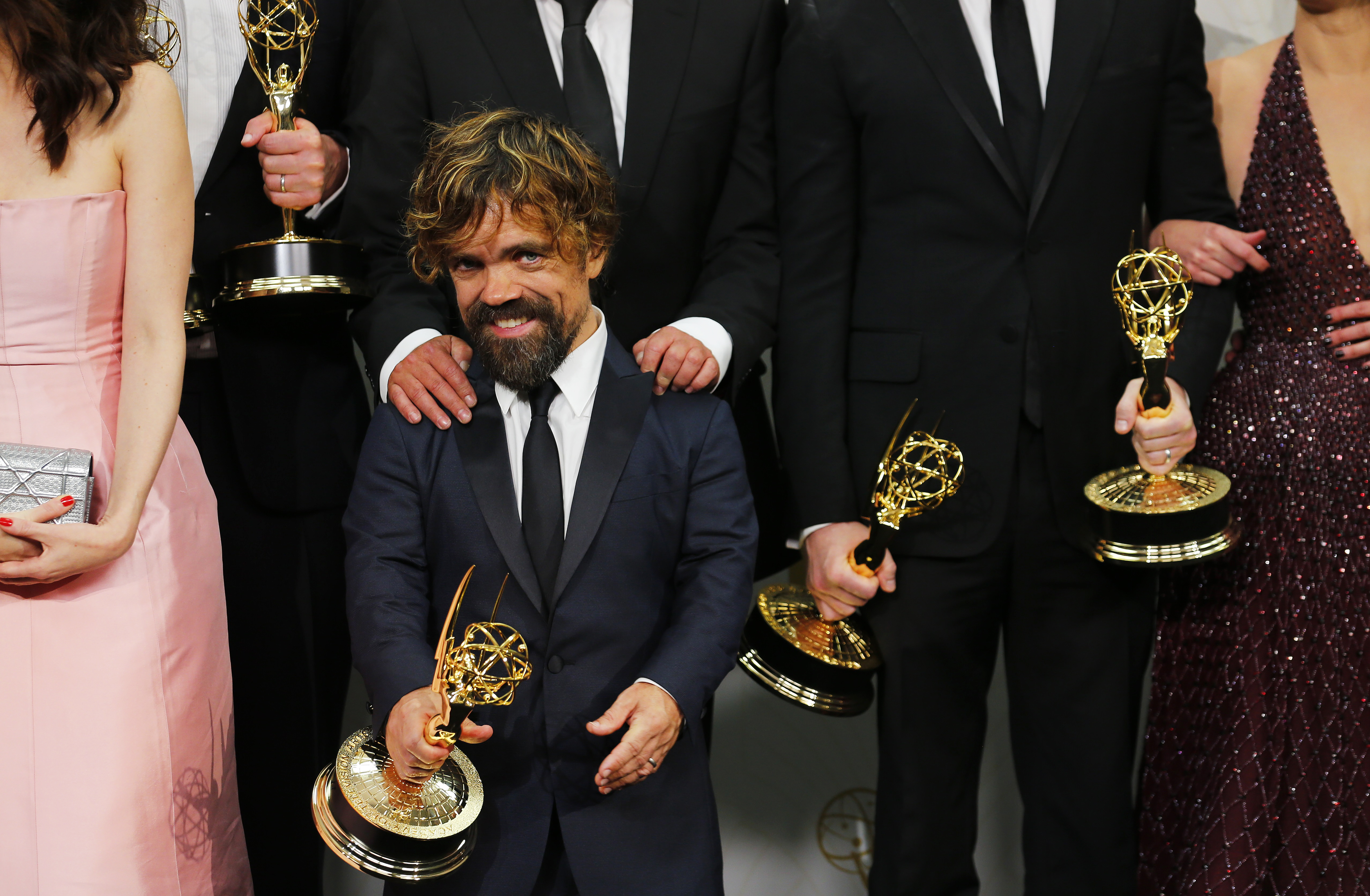 Peter Dinklage and the cast of the "Game of Thrones" pose backstage with their Outstanding Drama Series award during the 67th Primetime Emmy Awards in Los Angeles