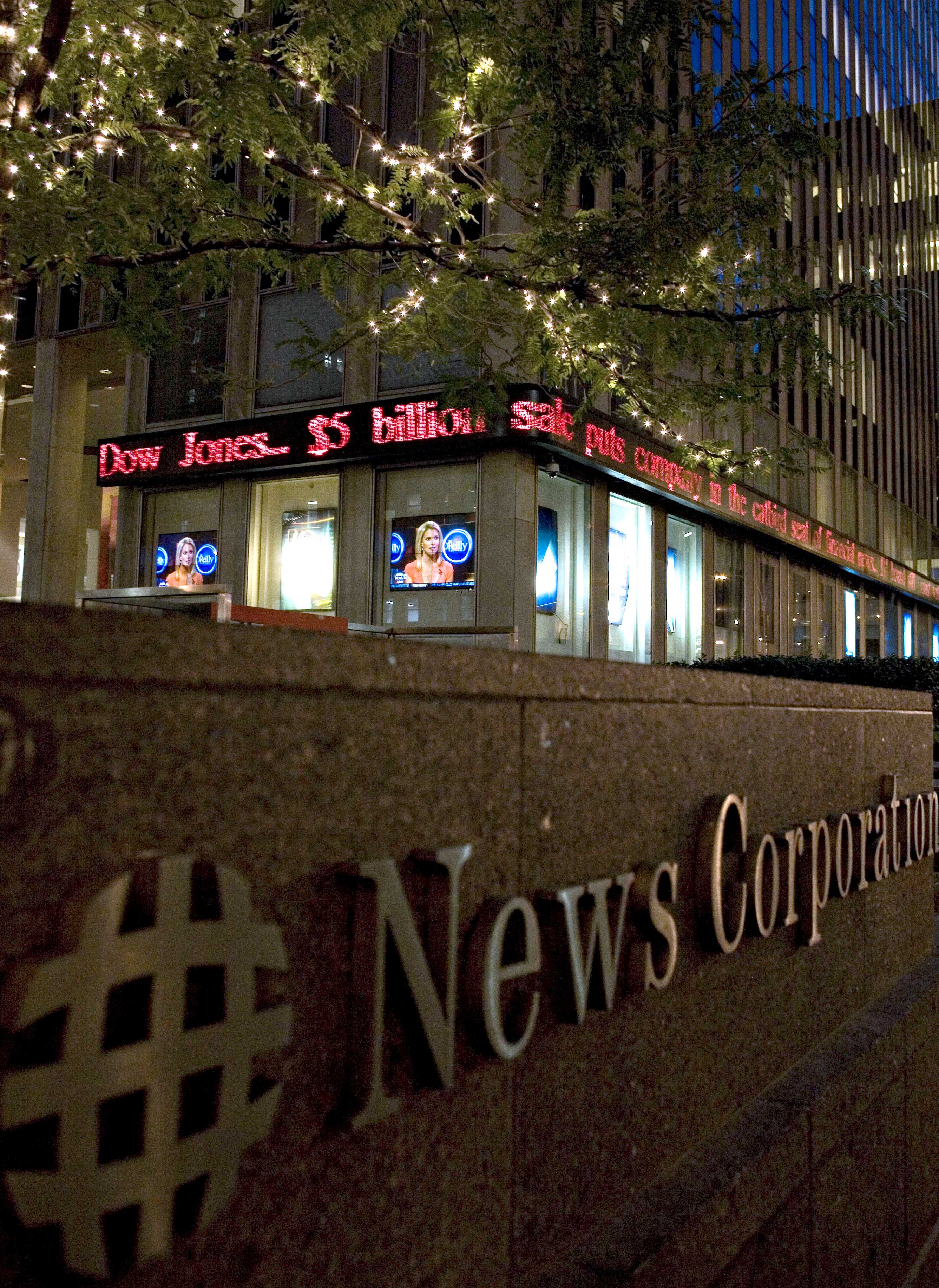 The headquarters of News Corp. displays headlines that the c