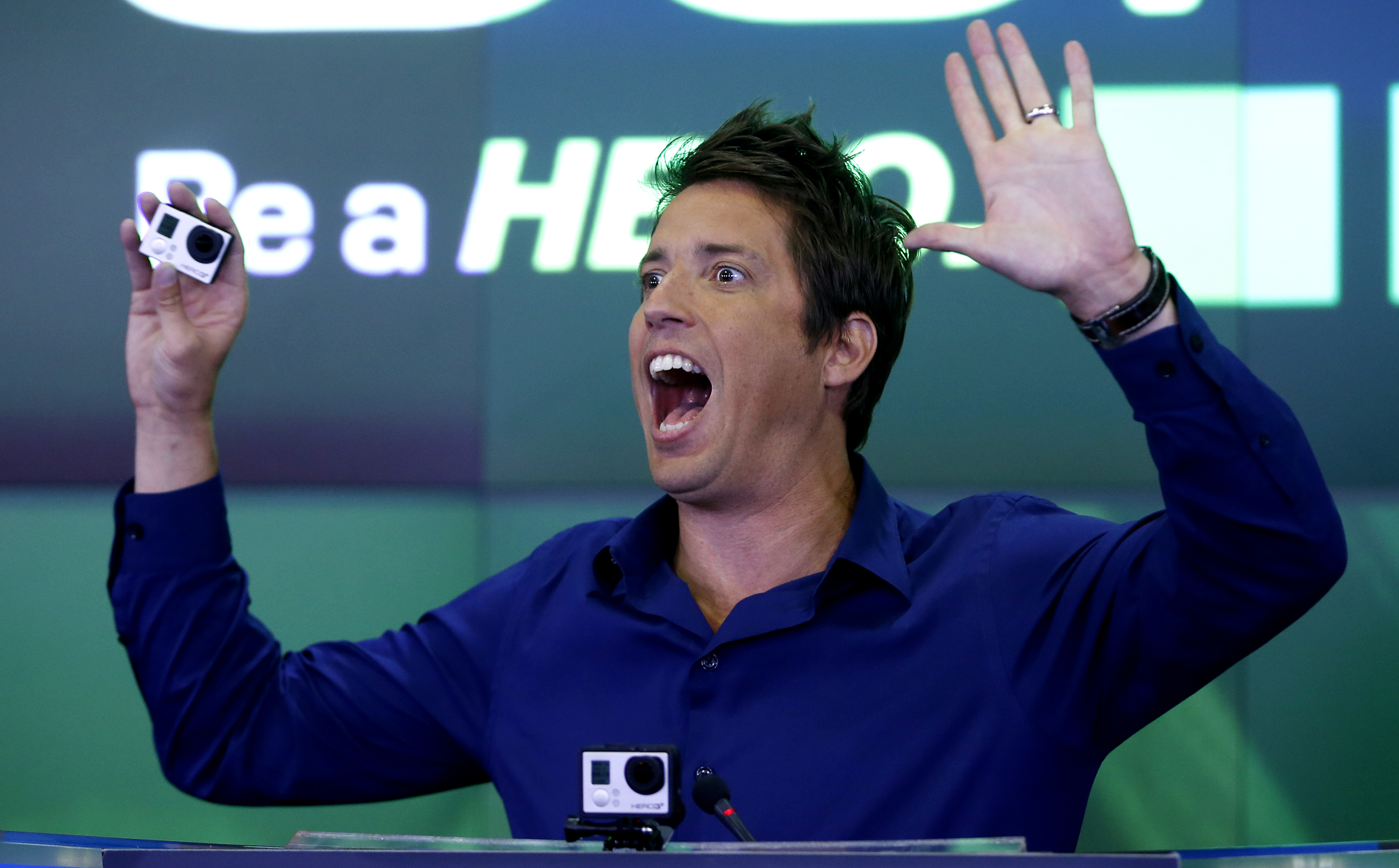 GoPro Inc's founder and CEO Woodman holds a GoPro camera as he celebrates GoPro Inc's IPO at the Nasdaq Market Site in New York