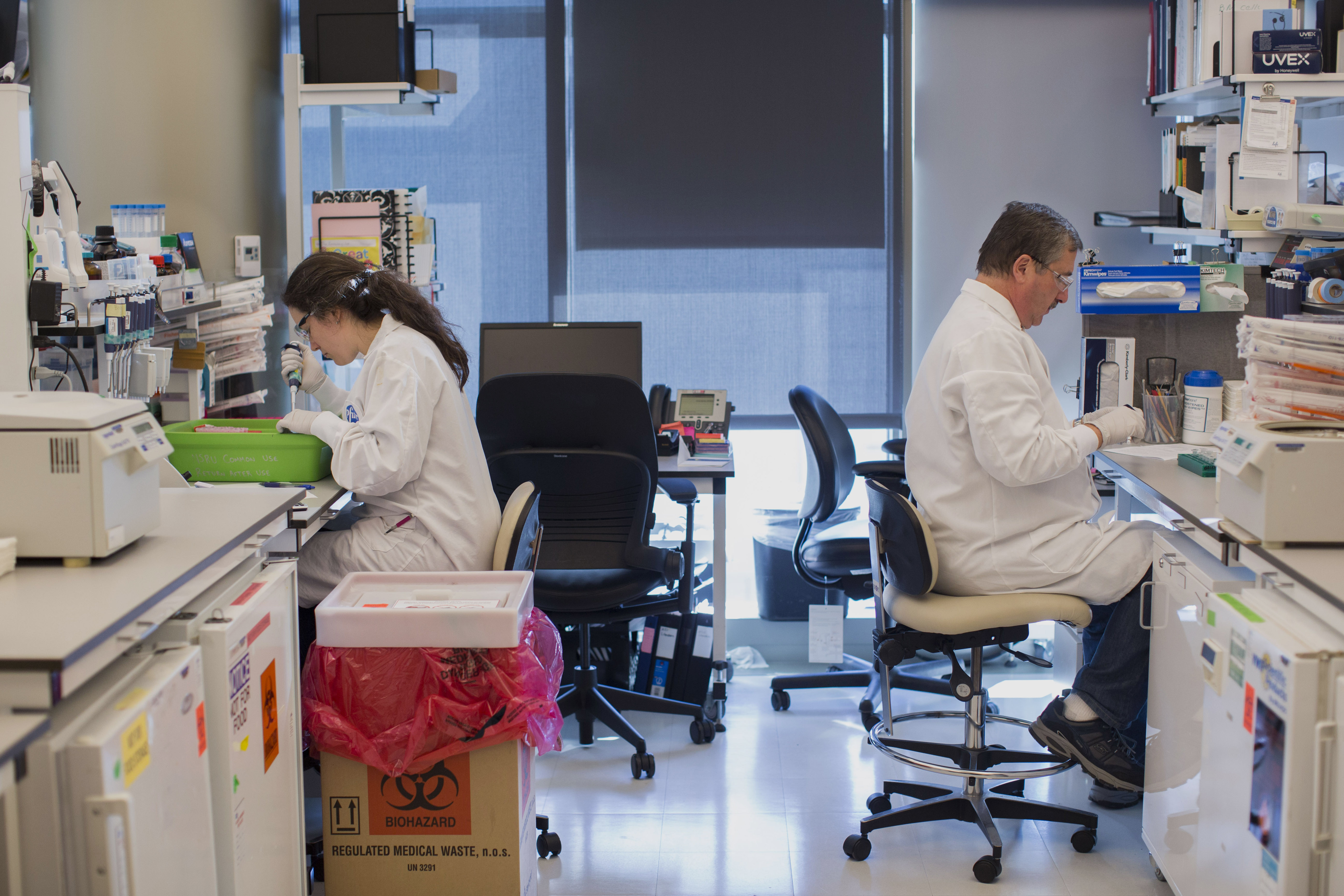 Pfizer employees inside of a laboratory at Pfizer's research and development facility in Cambridge, Massachusetts, U.S., on Monday, Oct. 26, 2015. Photographer: Scott Eisen/Bloomberg *** Local Caption ***