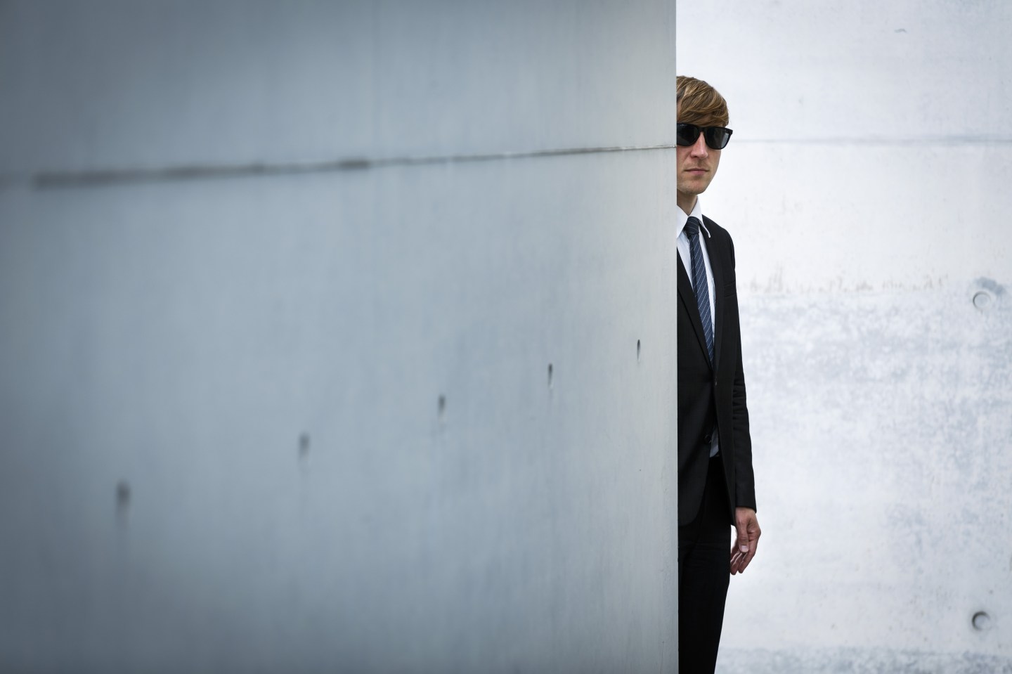 Man in suit reflects
