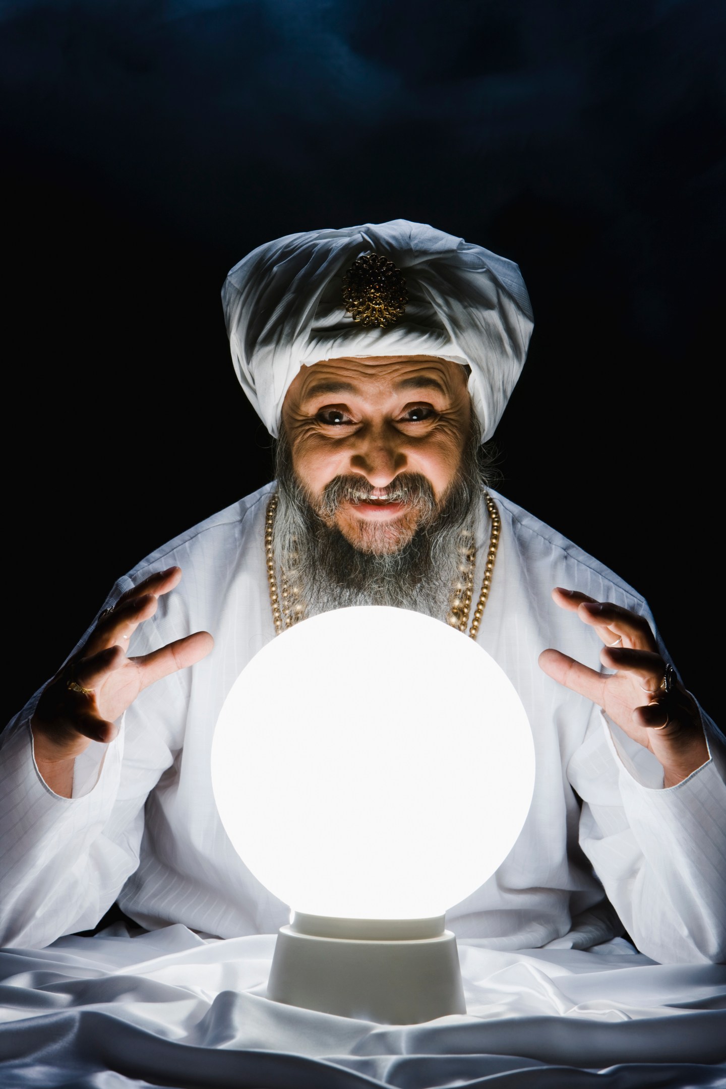 Male fortune teller and crystal ball