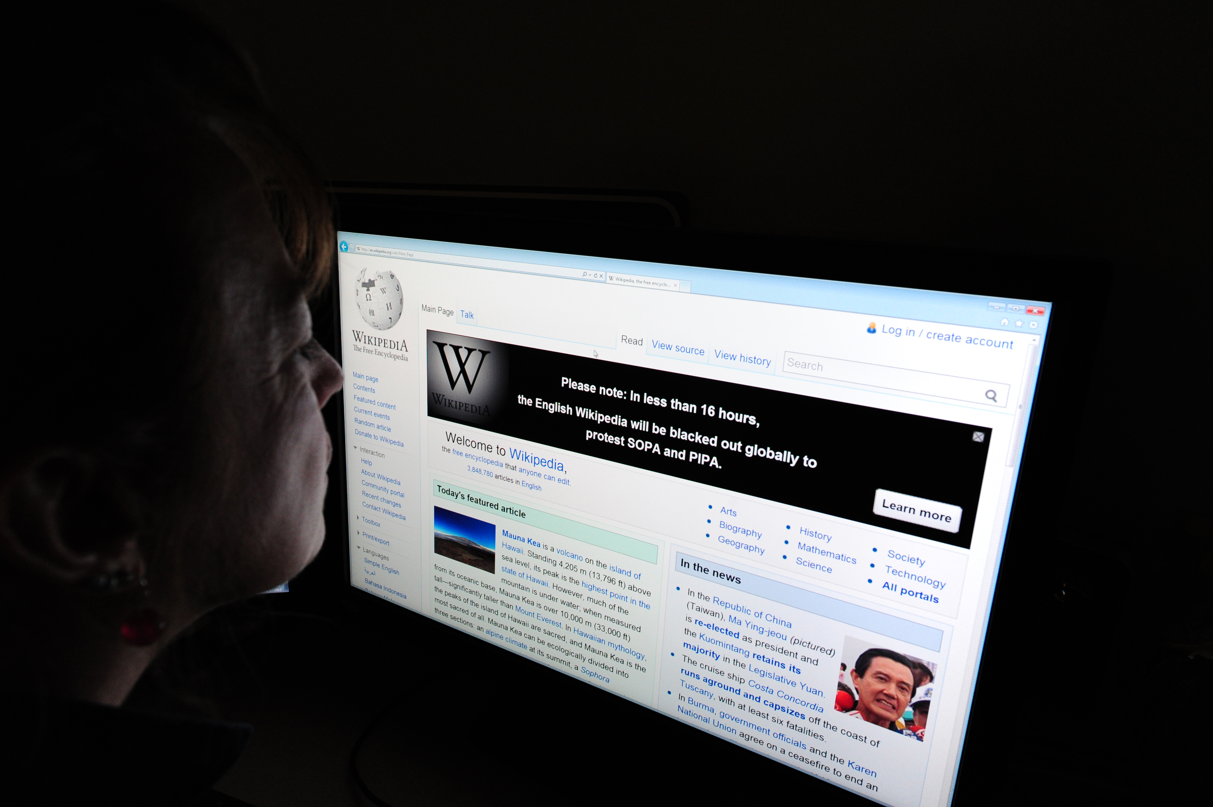 A journalist reads information on the on