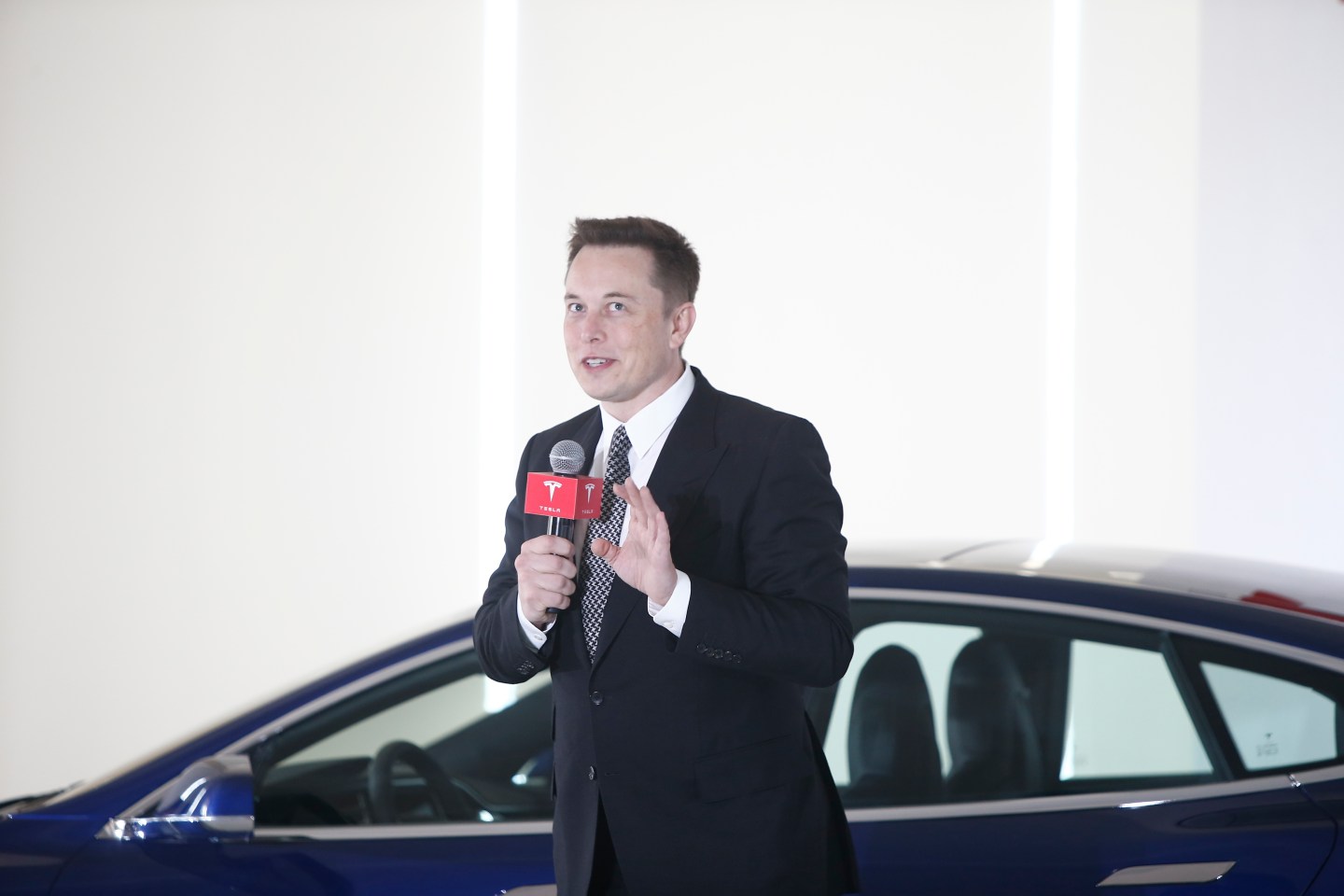 BEIJING, CHINA - OCTOBER 23: (CHINA OUT) Elon Musk, Chairman, CEO and Product Architect of Tesla Motors, addresses a press conference to declare that the Tesla Motors releases v7.0 System in China on a limited basis for its Model S, which will enable self-driving features such as Autosteer for a select group of beta testers on October 23, 2015 in Beijing, China. The v7.0 system includes Autosteer, a new Autopilot feature. While it's not absolutely self-driving and the driver still need to hold the steering wheel and be mindful of road conditions and surrounding traffic when using Autosteer. When set to the new Autosteer mode, graphics on the driver's display will show the path the Model S is following, post the current speed limit and indicate if a car is in front of the Tesla. (Photo by ChinaFotoPress)***_***