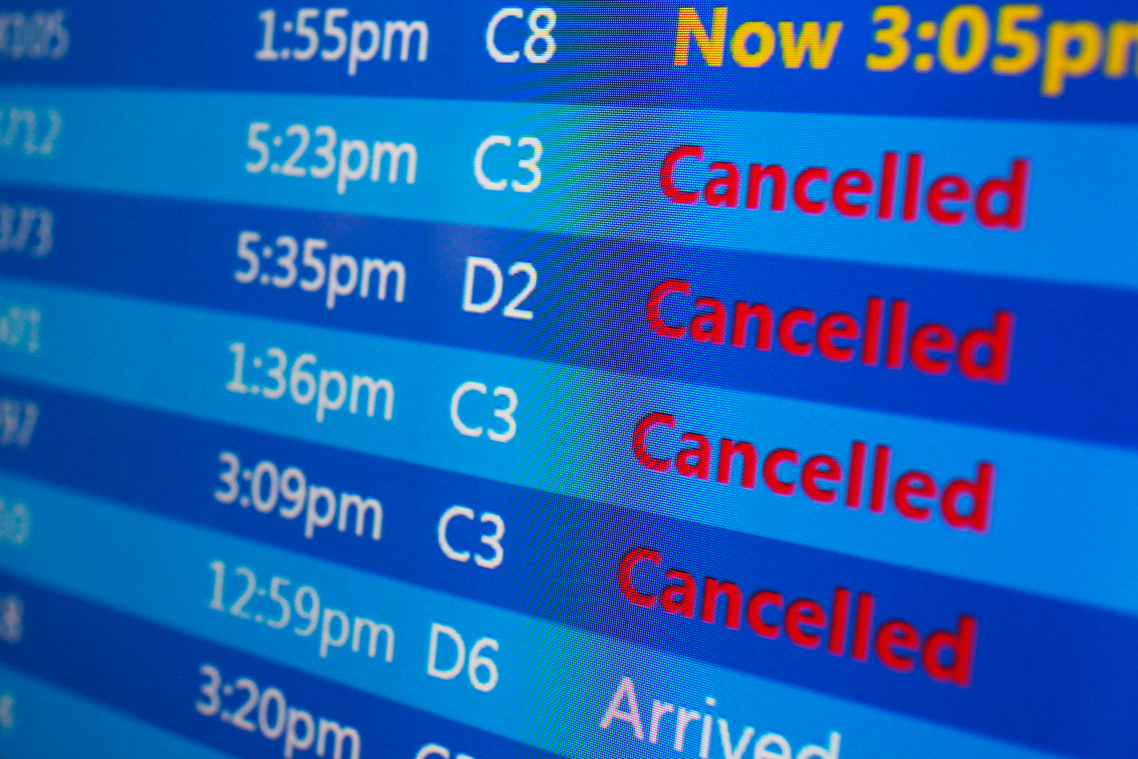Cancelled flights are displayed on a status board at New York's Laguardia Airport ahead of a powerful approaching winter storm