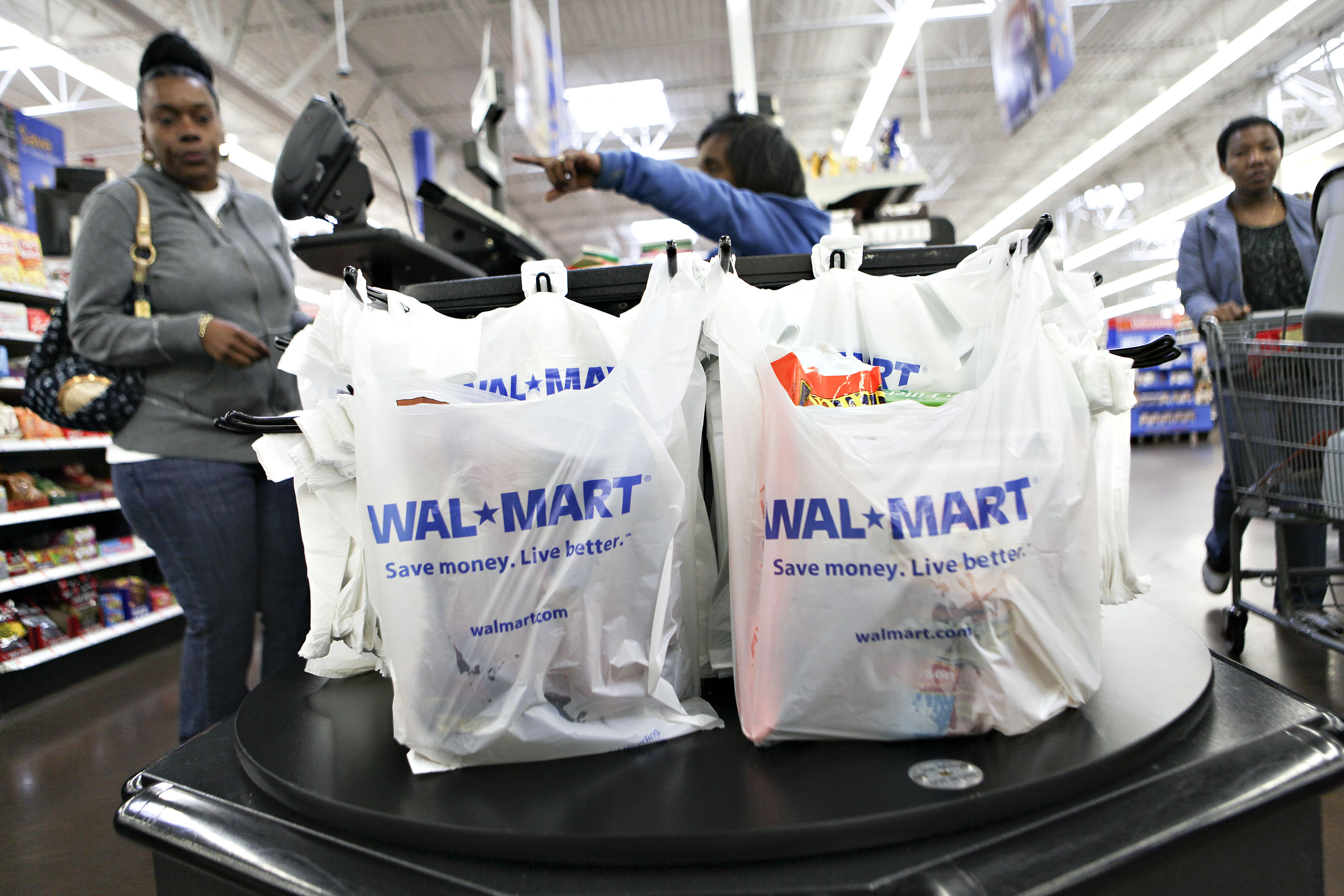 Wal-Mart logos apprear on shopping bags at a cash register i