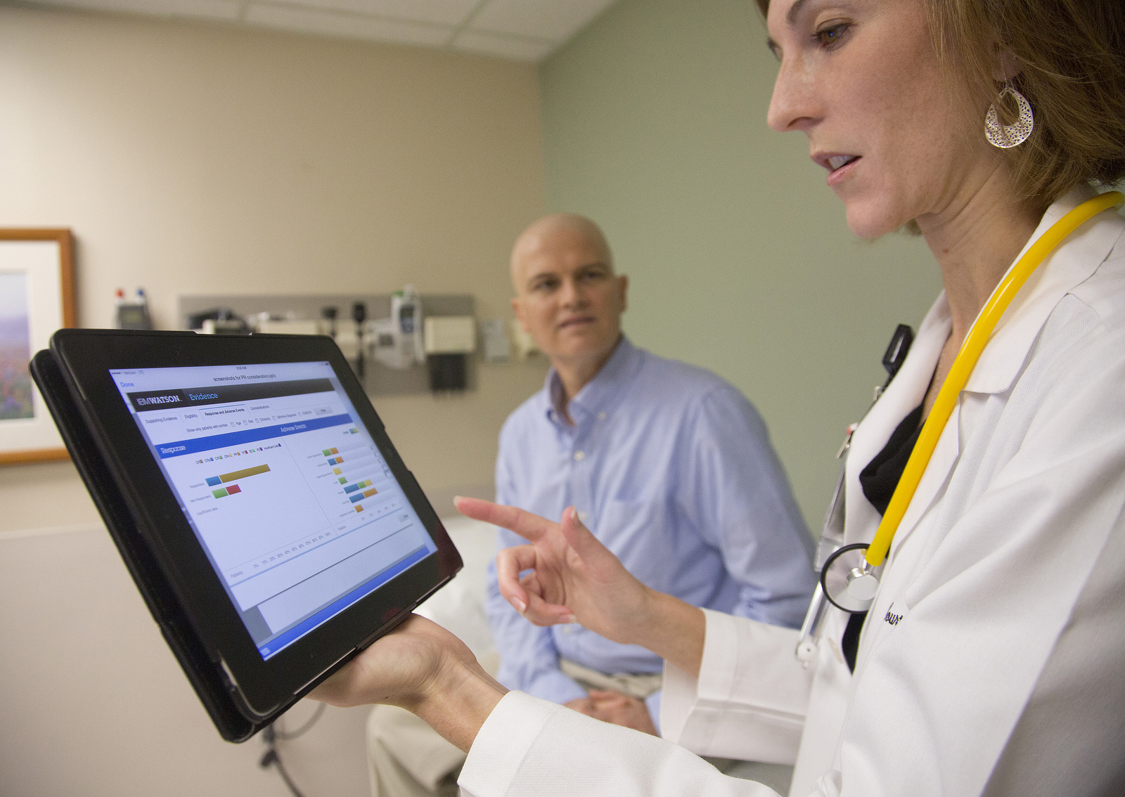 At the University of Texas MD Anderson Cancer Center, Assistant Professor of Leukemia Dr. Courtney DiNardo uses IBM's Watson cognitive system while consulting with patient Rich Ware. Starting with the fight against Leukemia, IBM's Watson will help MD Anderson physicians develop, observe and fine tune cancer treatment plans, match patients with clinical trials and recognize adverse effects during ongoing care. (Feature Photo Service)