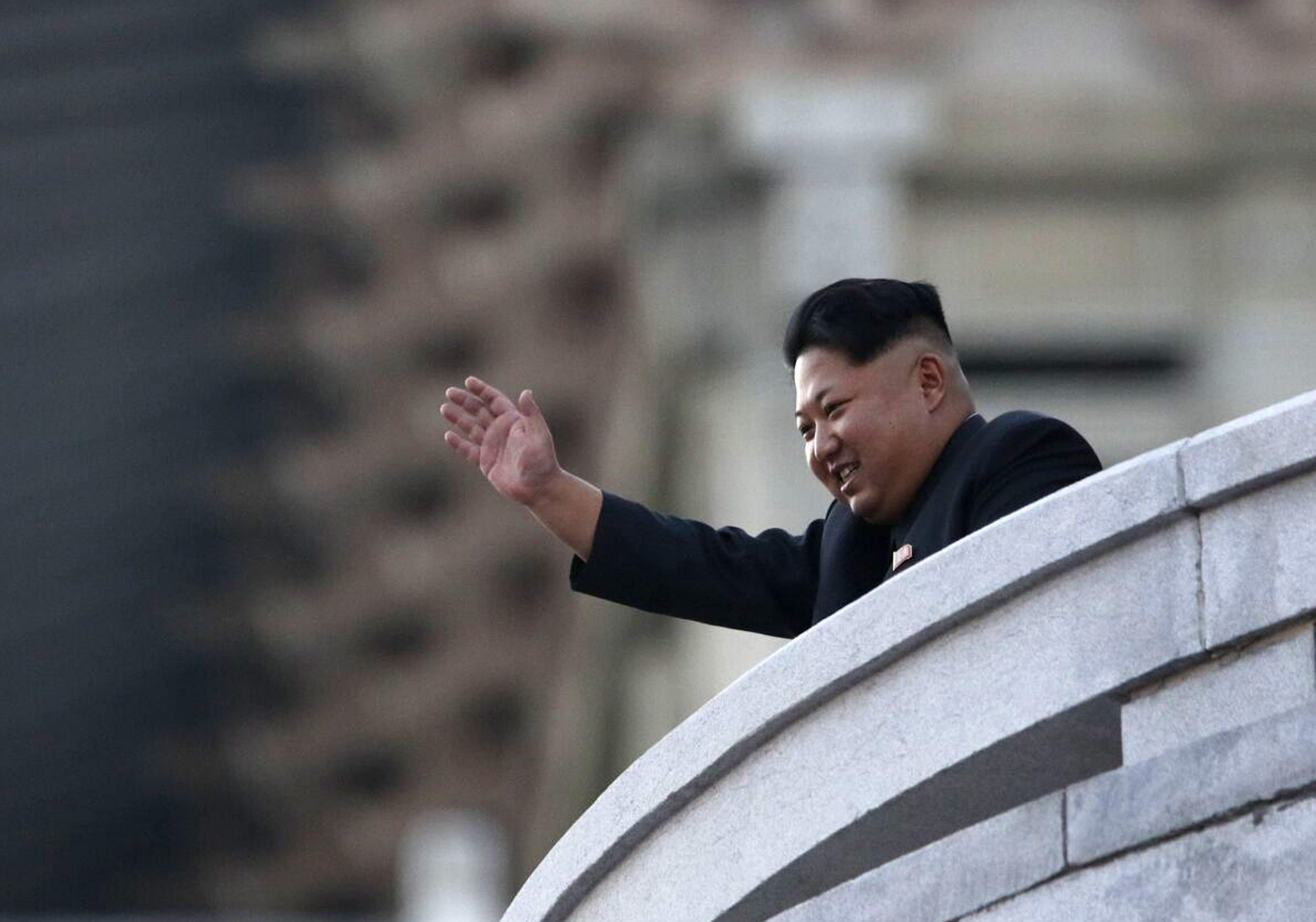 PYONGYANG, NORTH KOREA - OCTOBER 10: (CHINA OUT) North Korea's leader Kim Jong-Un waves from a balcony towards participants of a mass military parade at Kim Il-Sung square to mark the 70th anniversary of its ruling Worker's Party of Korea on October 10, 2015 in Pyongyang, North Korea. (Photo by ChinaFotoPress/ChinaFotoPress via Getty Images)