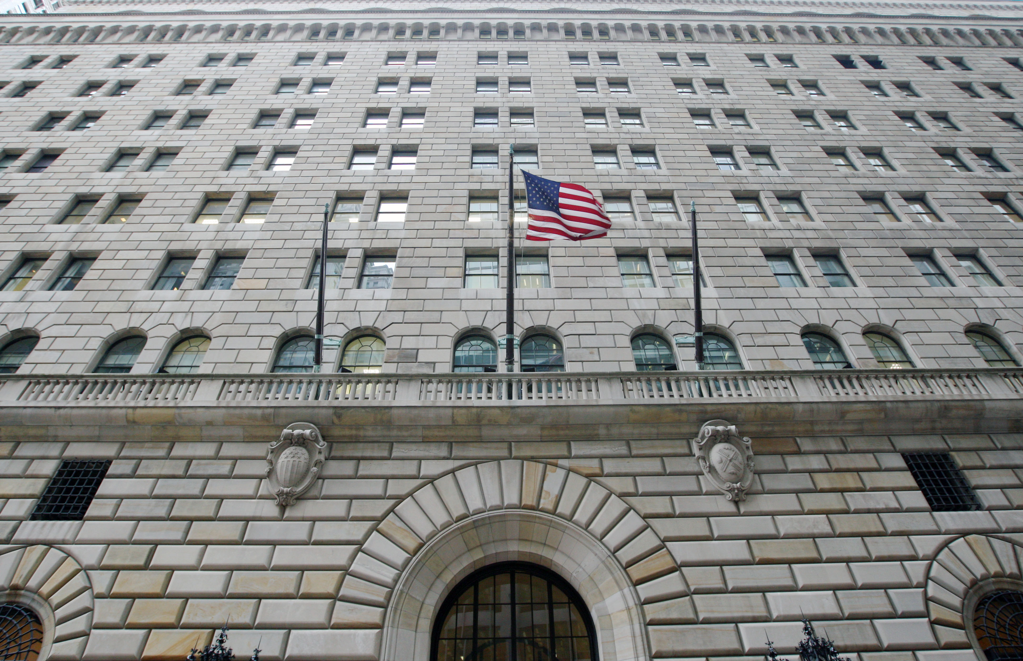 The U.S. flag hangs on the facade of the Federal Reserve Ban