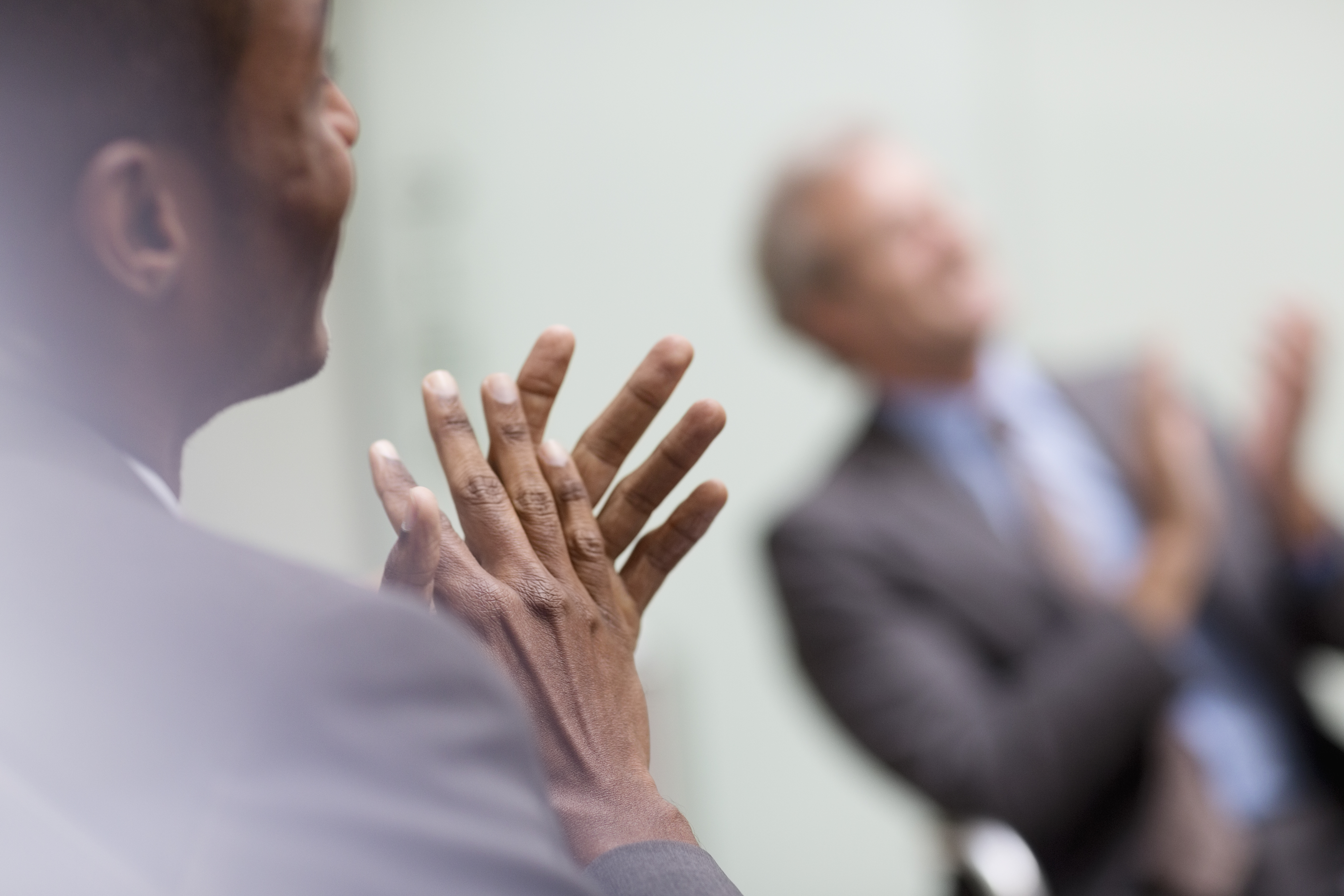 Businessmen clapping in meeting