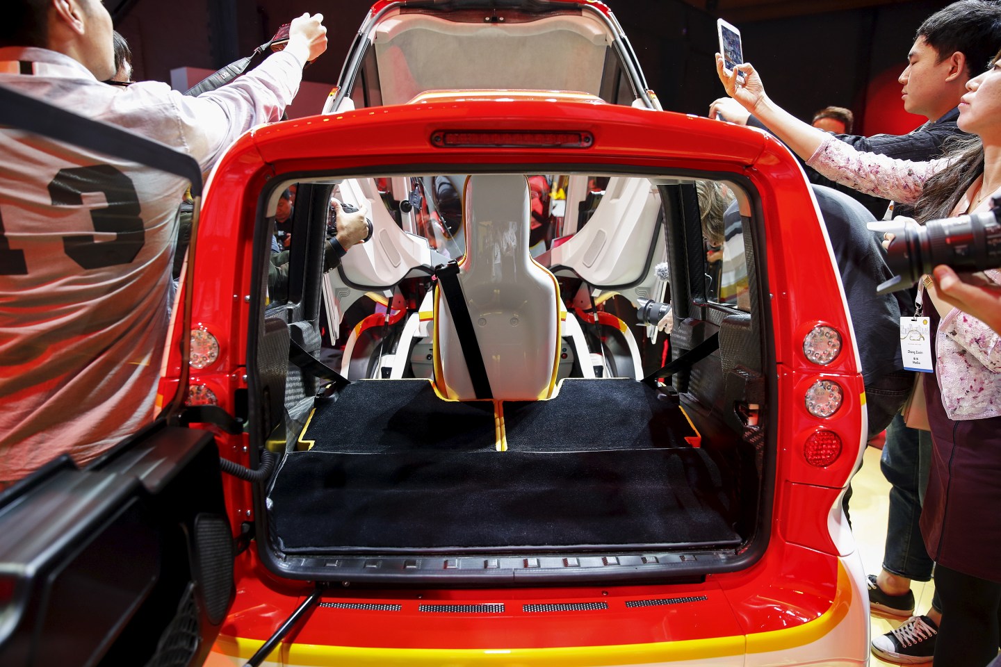 People take pictures of a high-efficiency petrol-burning concept car as it is unveiled by Royal Dutch Shell during a ceremony in Beijing