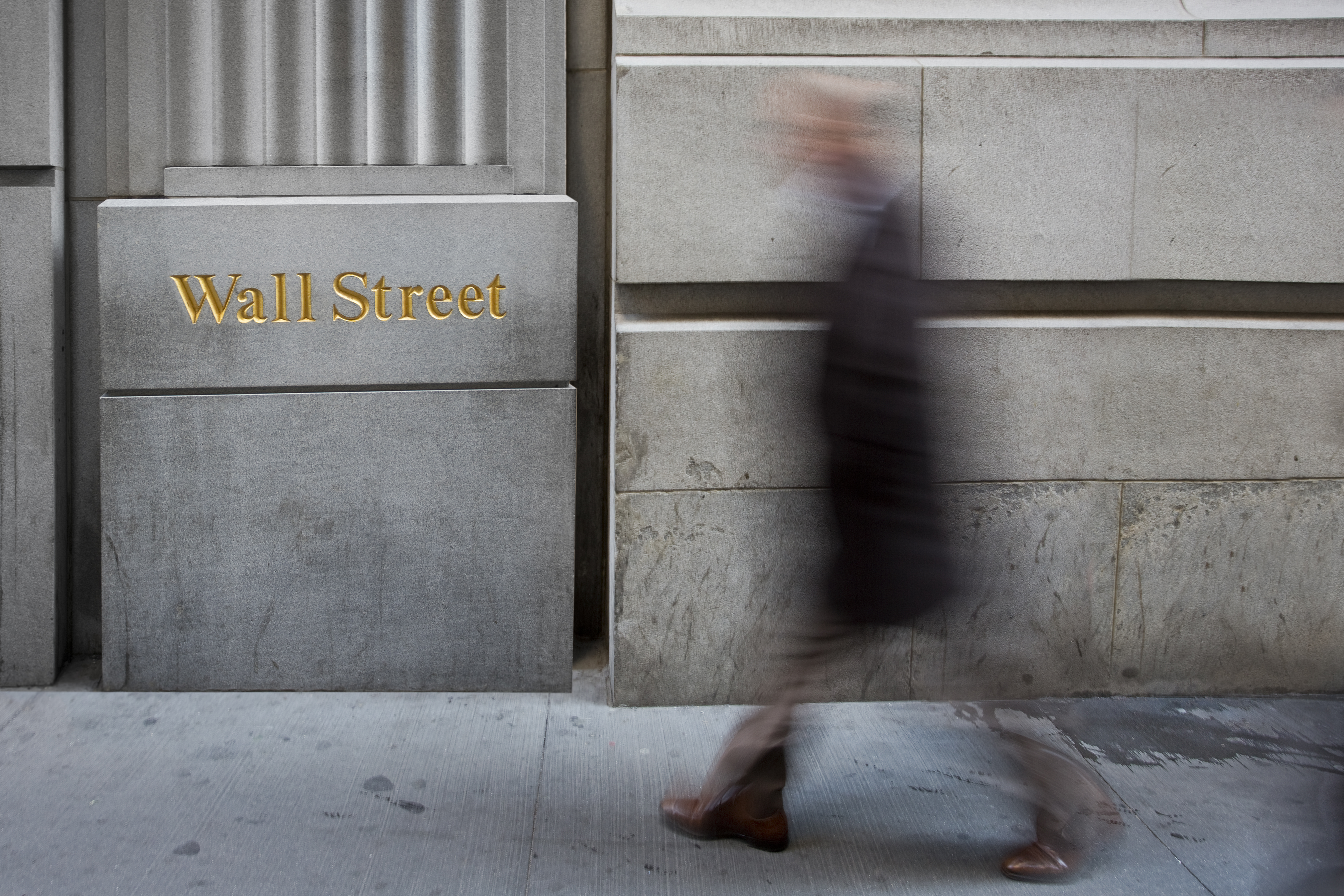 A blurred figure on Wall Street in New York