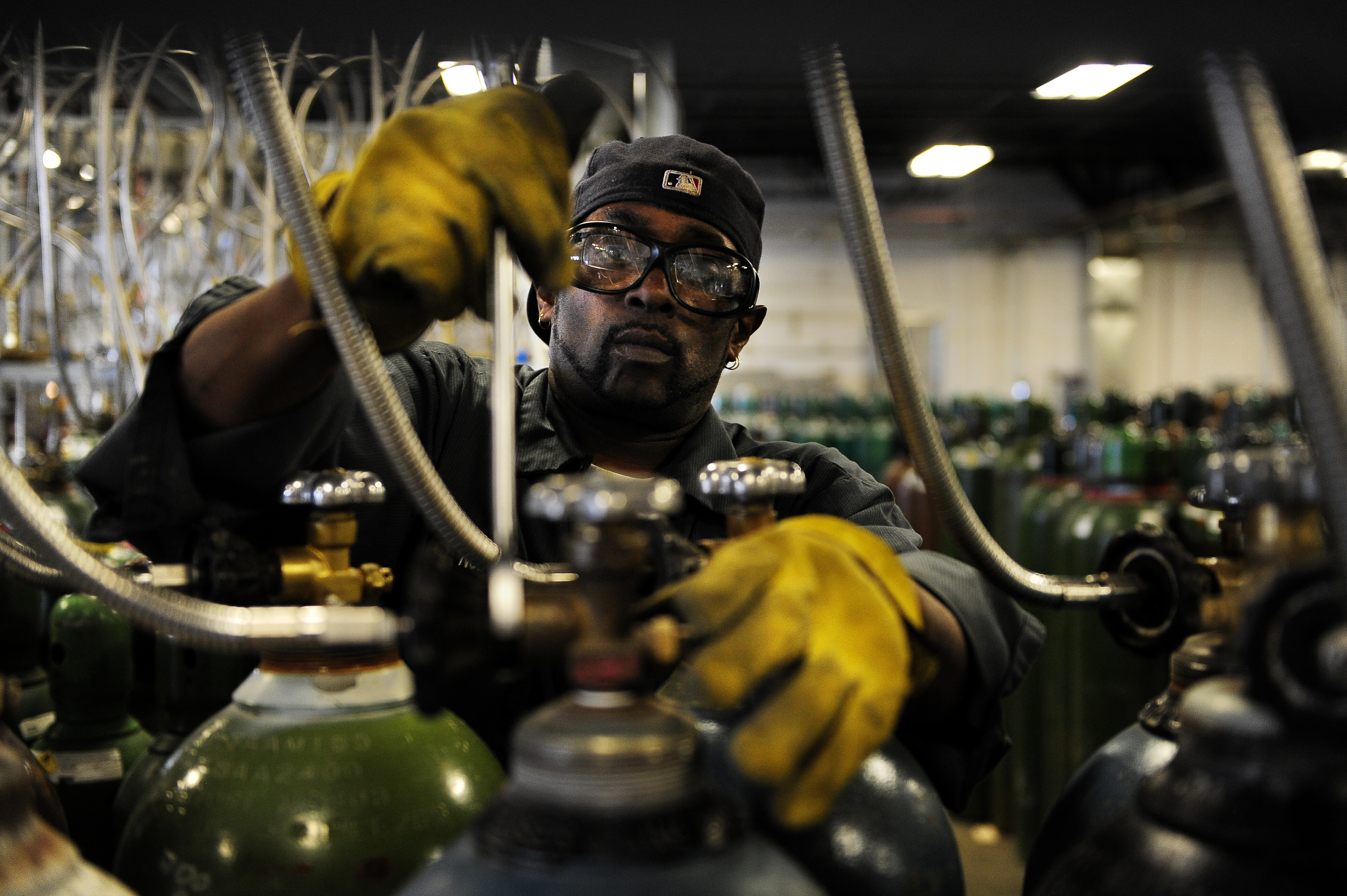 Cylinder filler Norman Coleman disconnects the lines from the nitrogen tanks he's just filled at the Airgas Intermountain Plant in Commerce City. Unemployment insurance tax rates are up about 40 percent this year compared to last in Colorado. But it all d