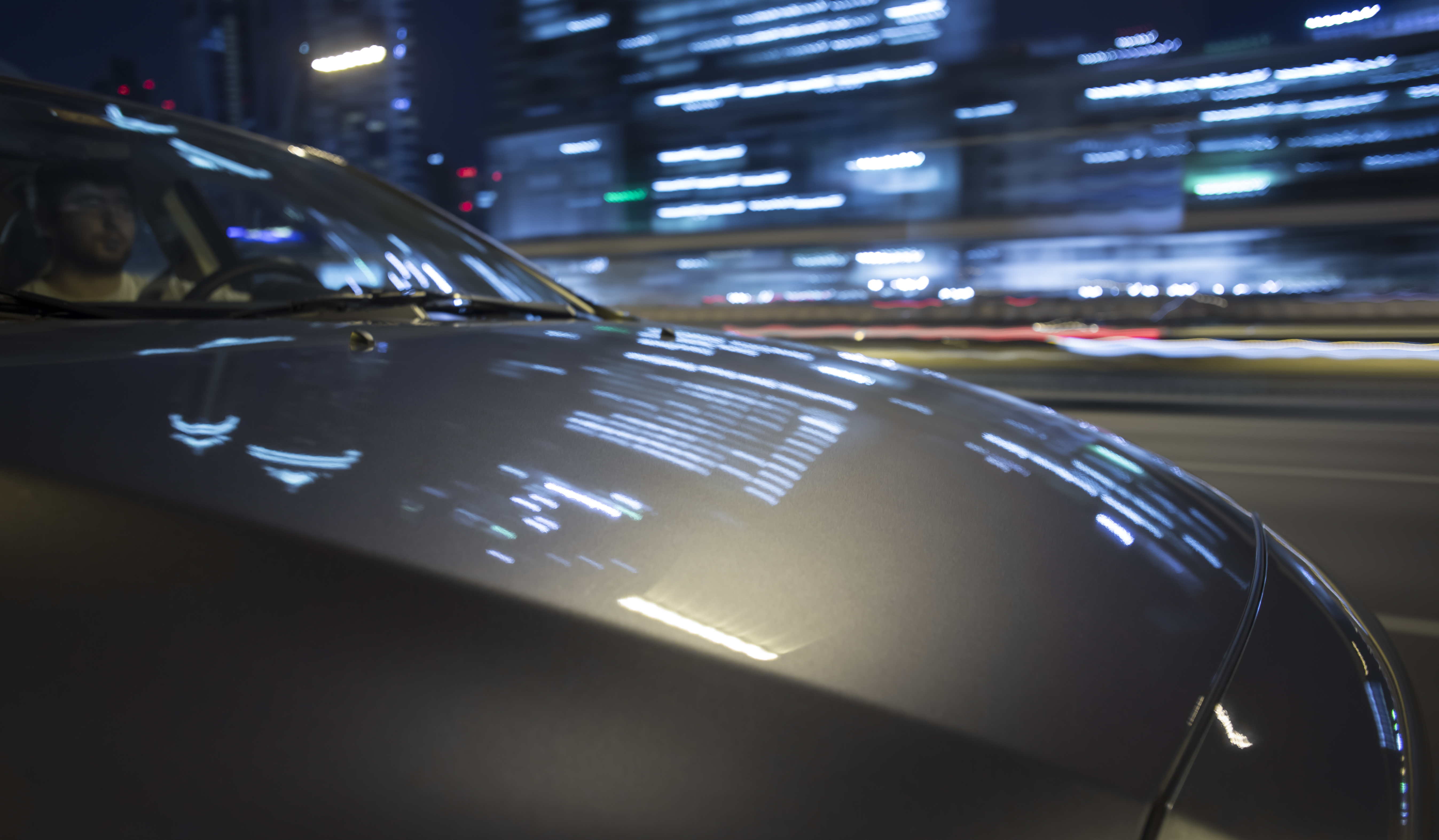 on board a driving car - hood in foreground