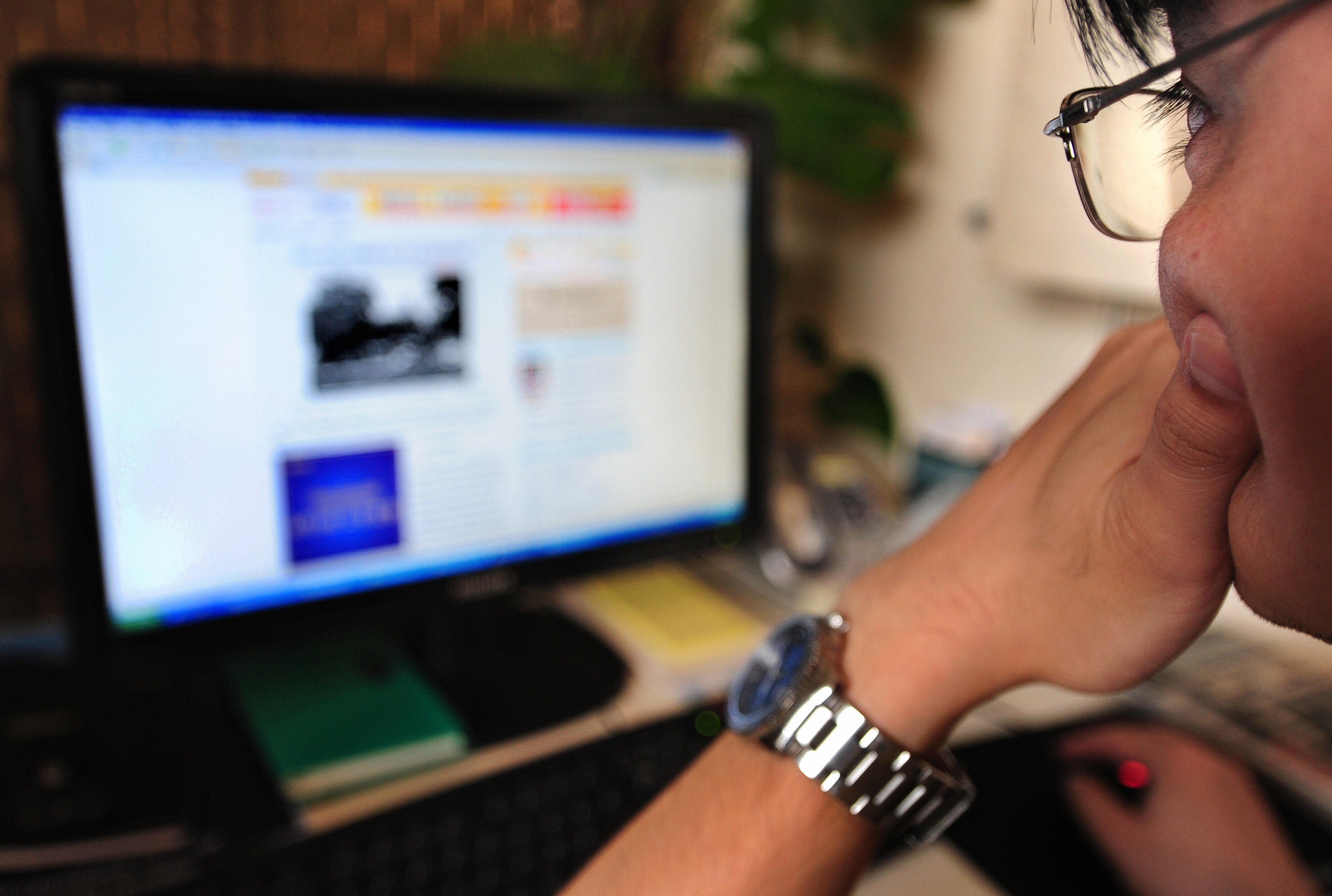 A man surfs the internet in Beijing on J