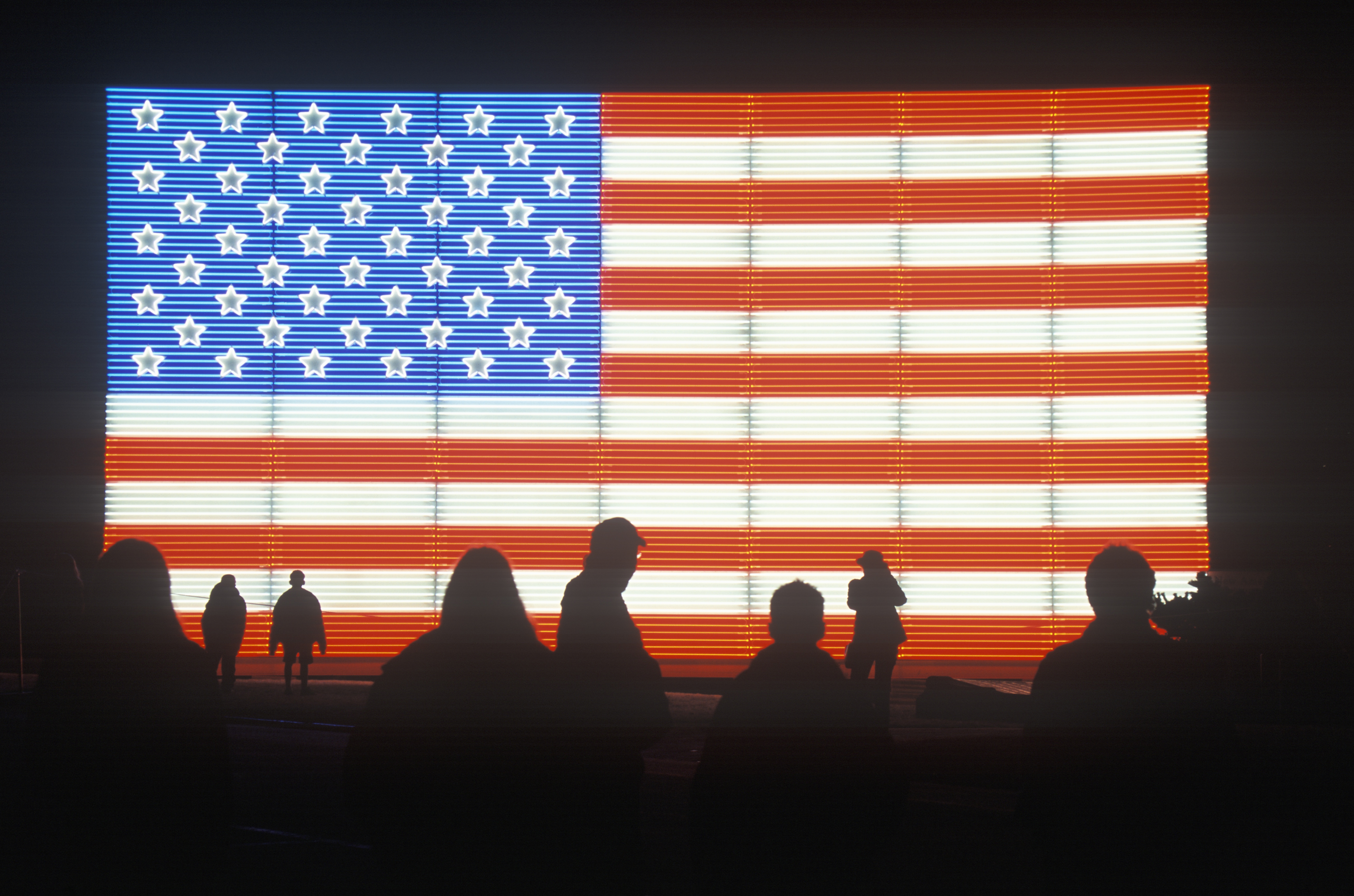 "Silhouettes of People in front of an American electric Flag, Winter Olympics, Salt Lake City, Utah"