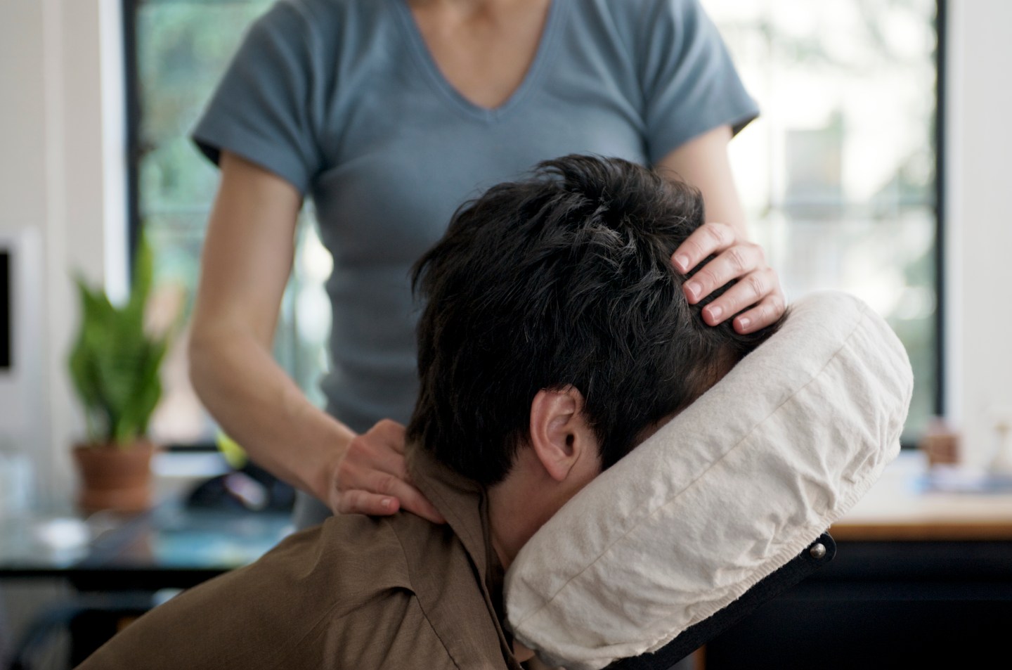 Man Getting Mobile Chair Massage in an Office