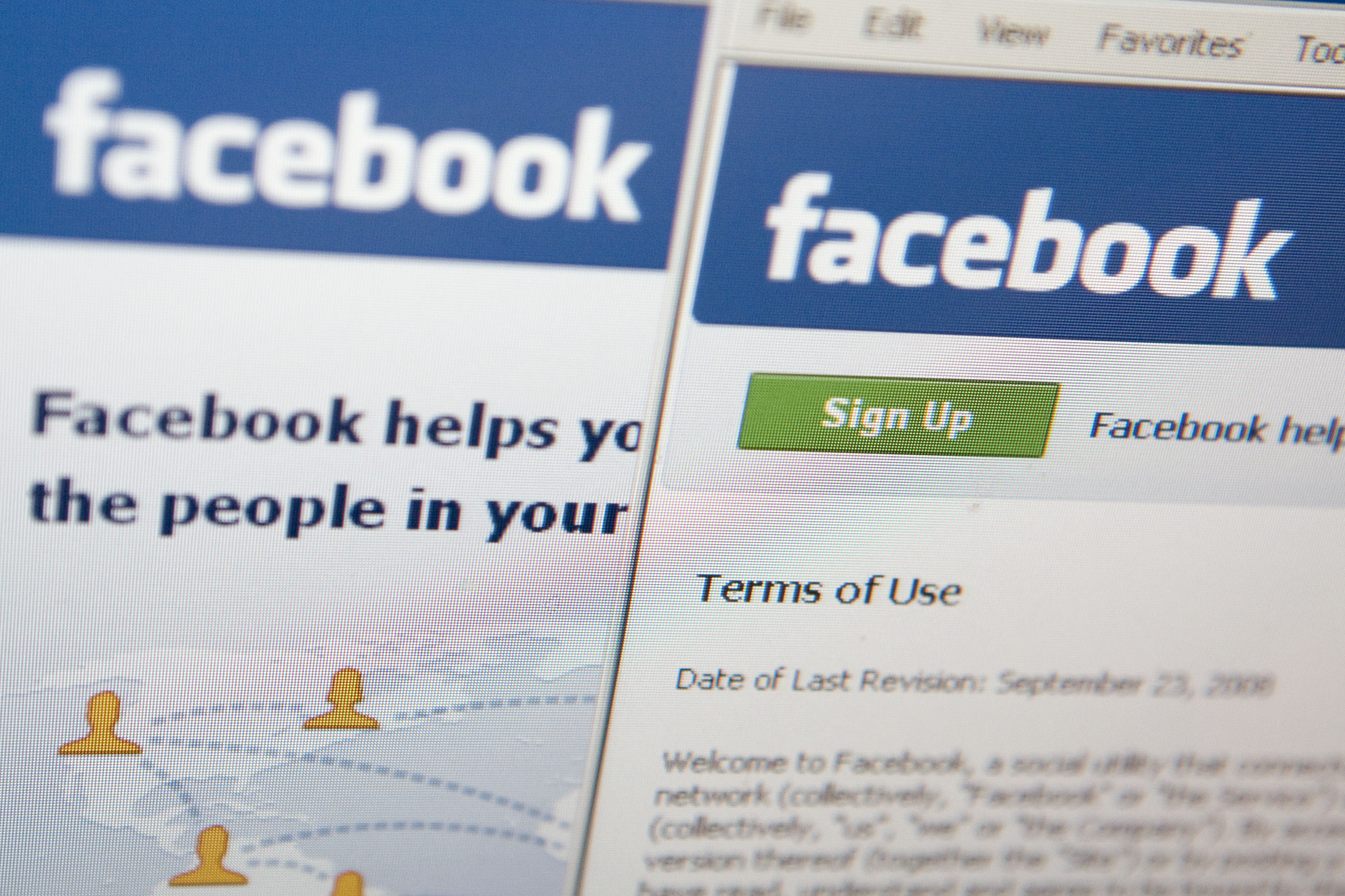 The Facebook terms of use are displayed on a computer monito