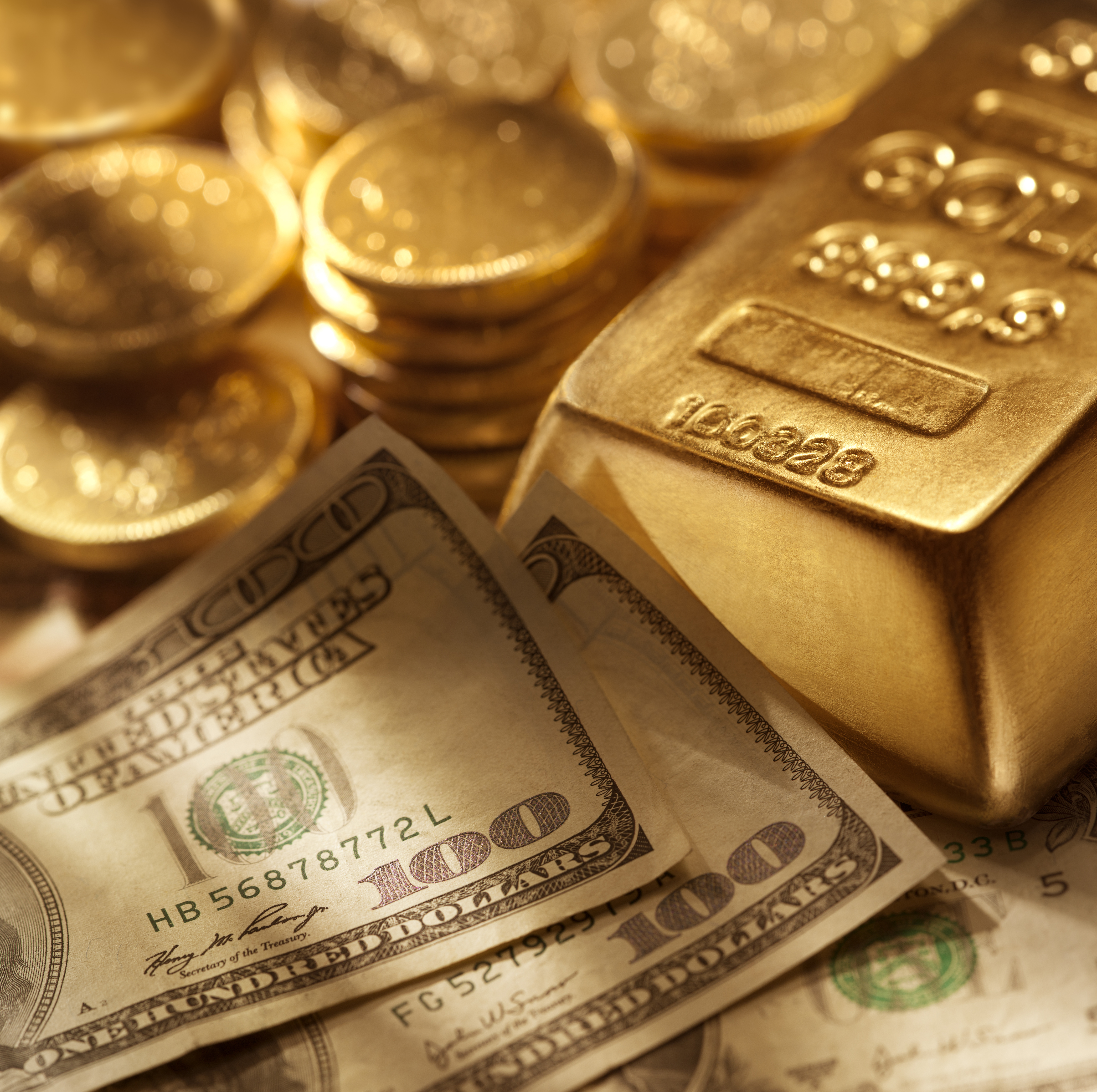 Hundred dollar bills surrounded by gold