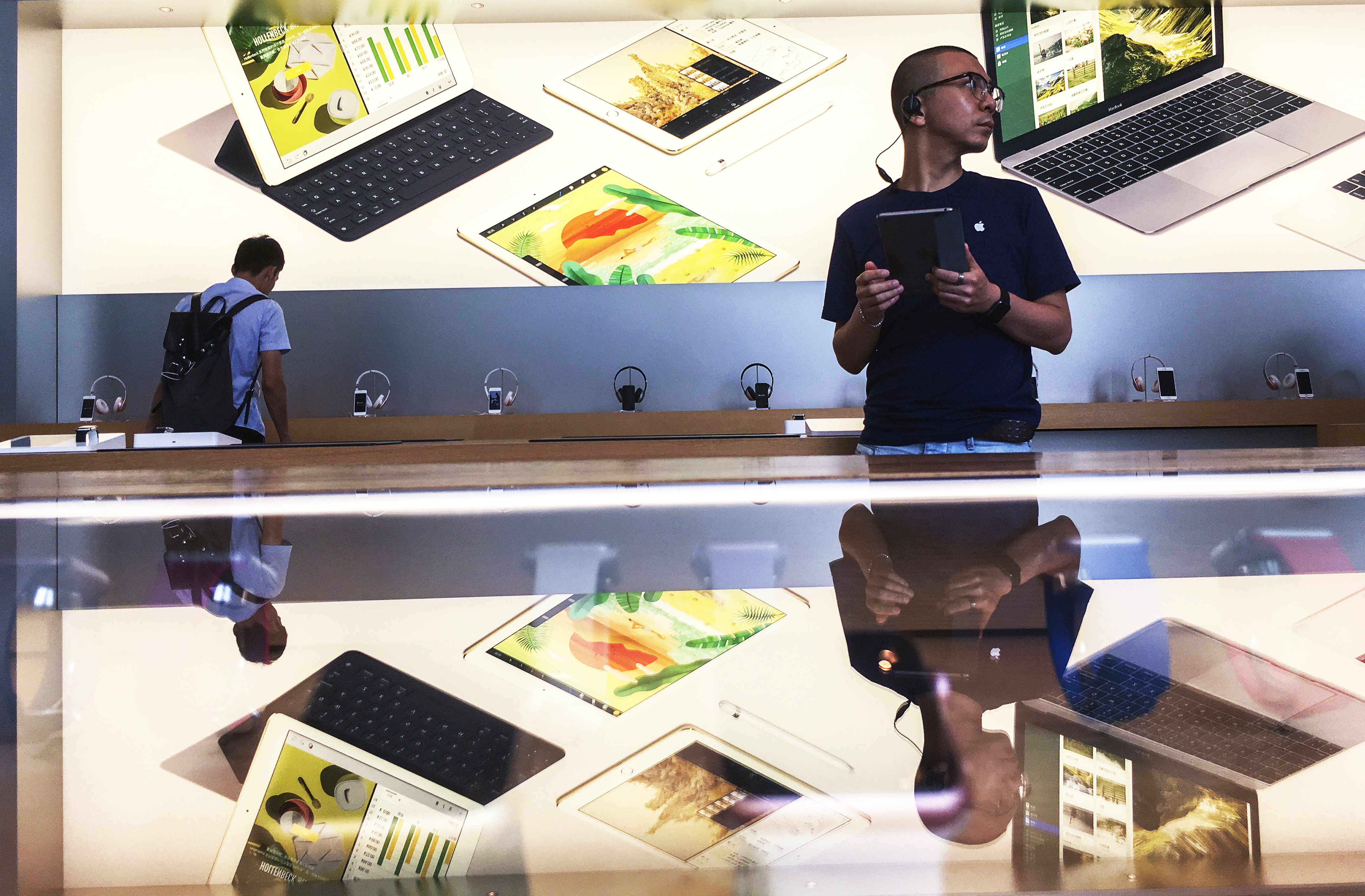Customers in an Apple shop in Beijing Dawanglu CBD. As