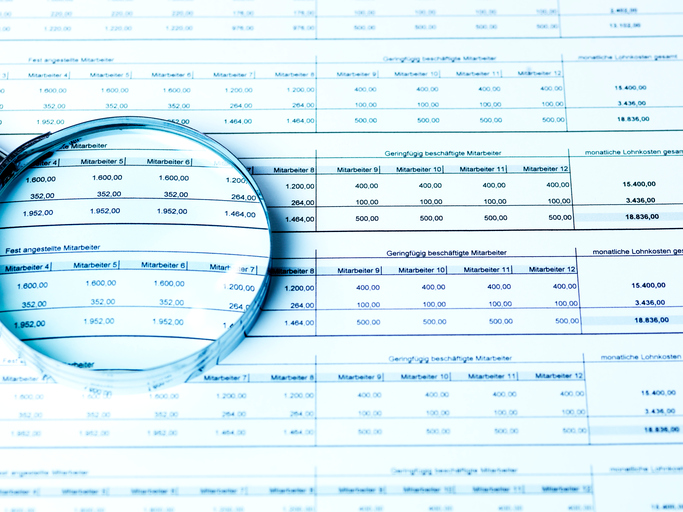 High Angle View Of Magnifying Glass On Document In Office