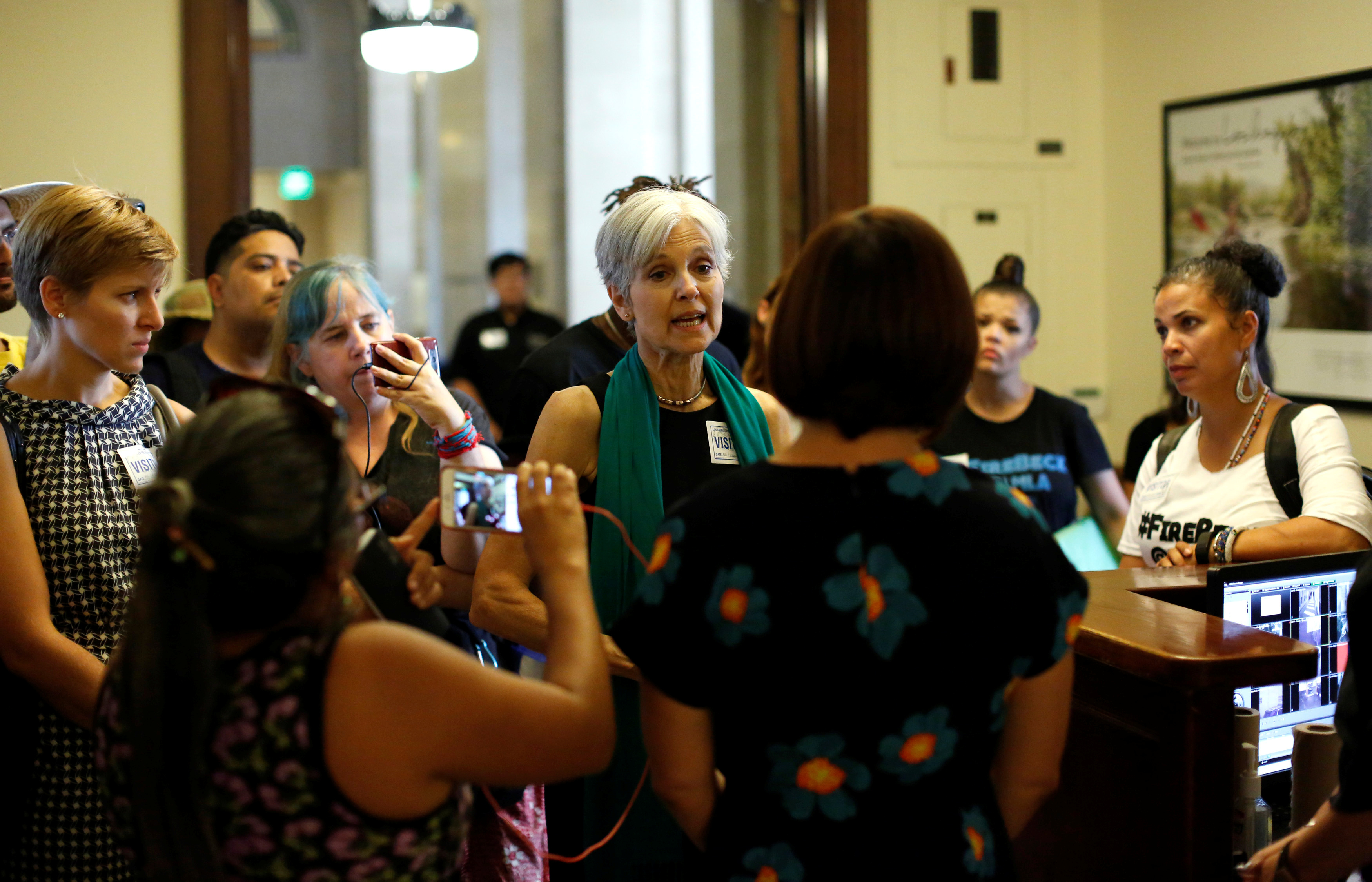 Green Party presidential candidate Stein and activists from Black Lives Matter speak with an employee as they attempt to meet with the mayor at City Hall in Los Angeles