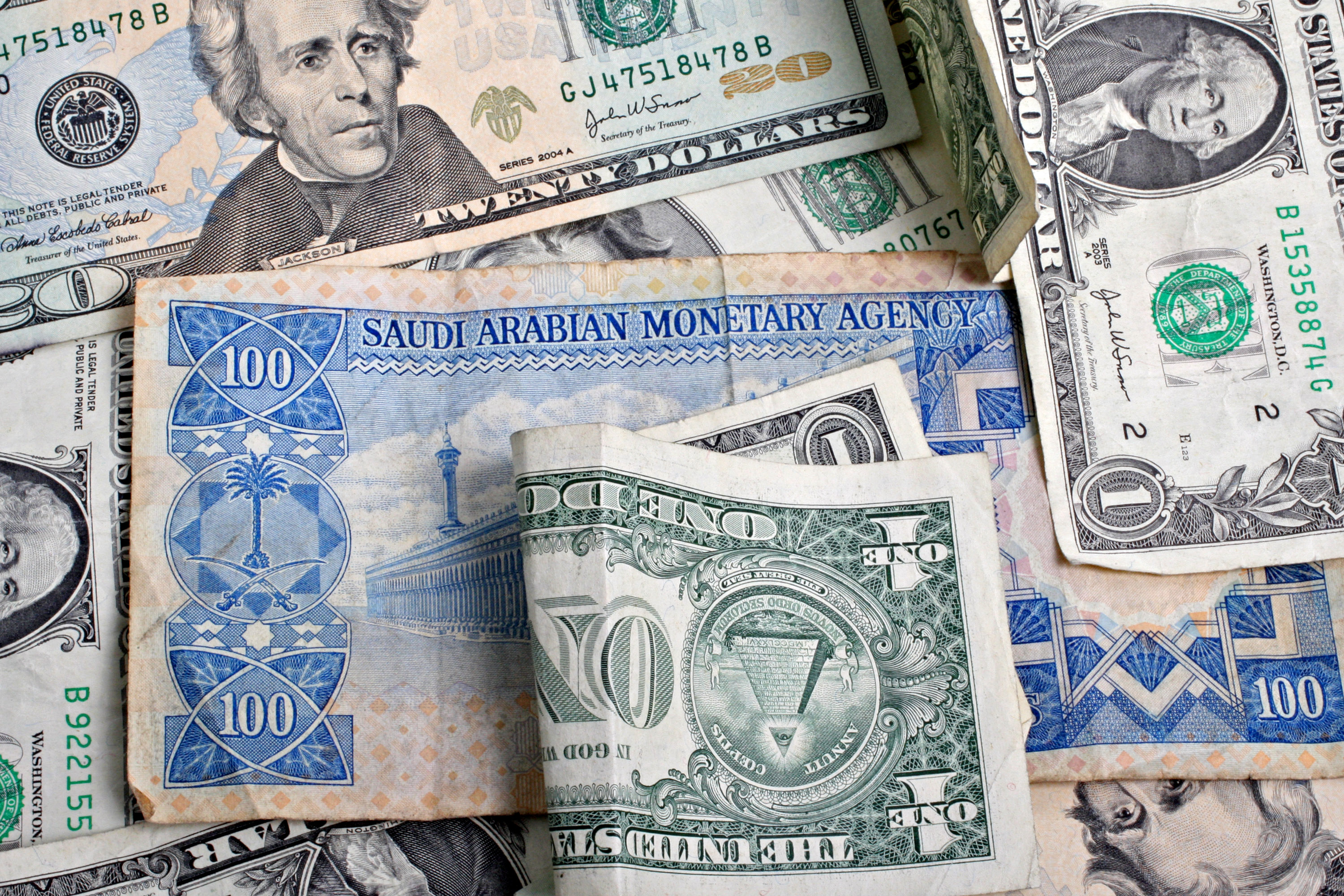 A Saudi Arabian one hundred riyal note and an assortment of