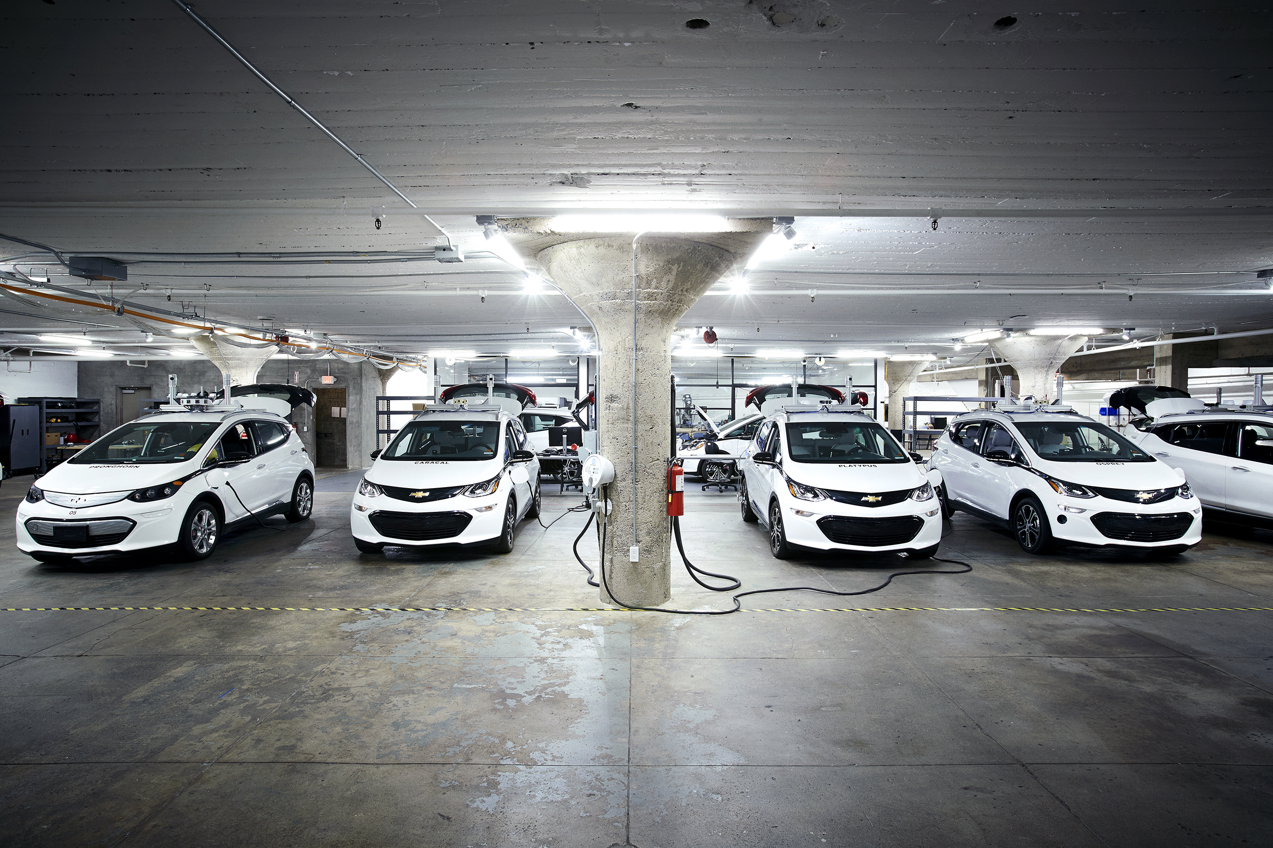 Electric-powered Chevrolet Bolts in Cruise Automation’s San Francisco garage. Cruise is working with GM to add autonomous-driving technology to the Bolt.