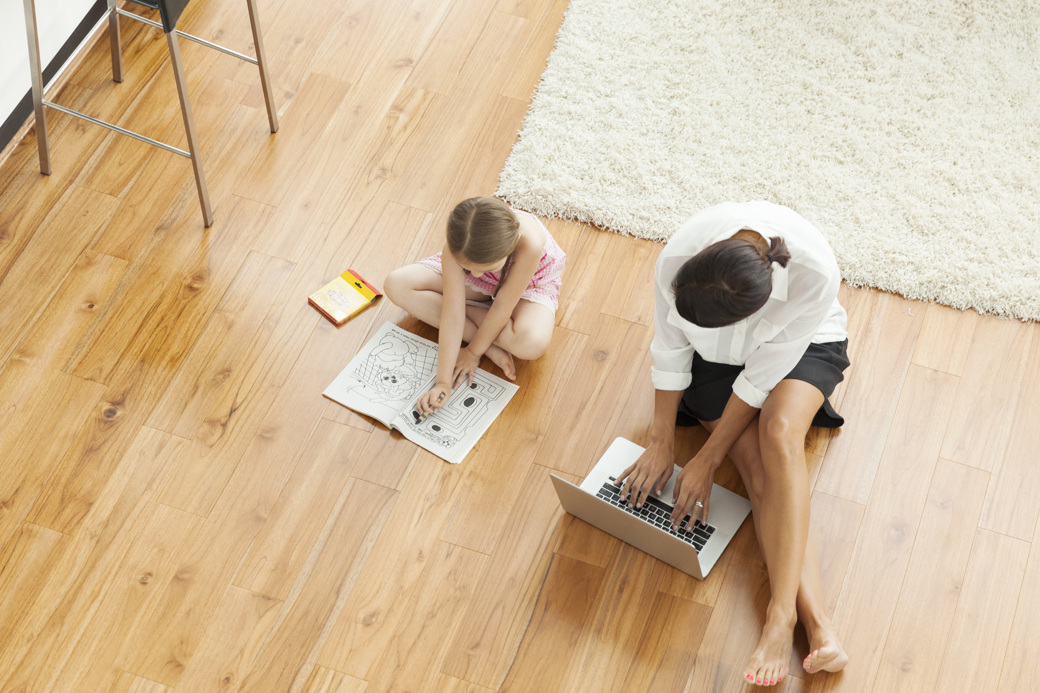 Mother and girl (6-7) on floor in living room