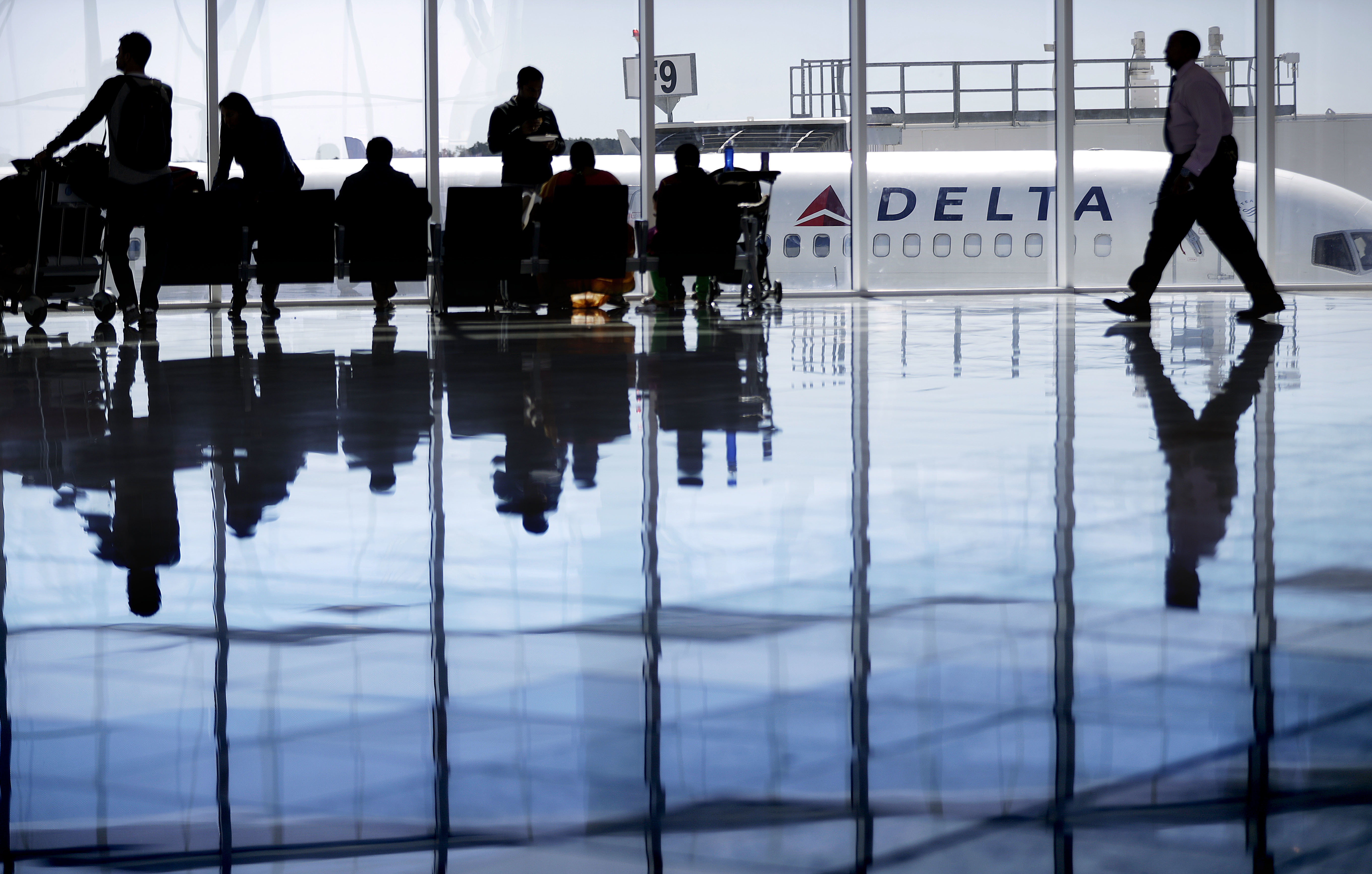 A Delta Air Lines jet sits at a gate at Hartsfield-Jackson Atlanta International Airport, in Atlanta, Thursday, Oct. 13, 2016.