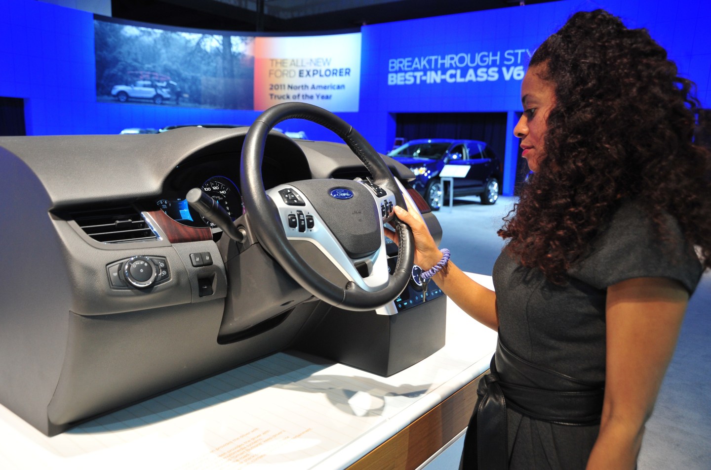 An auto show employee demonstrates Ford