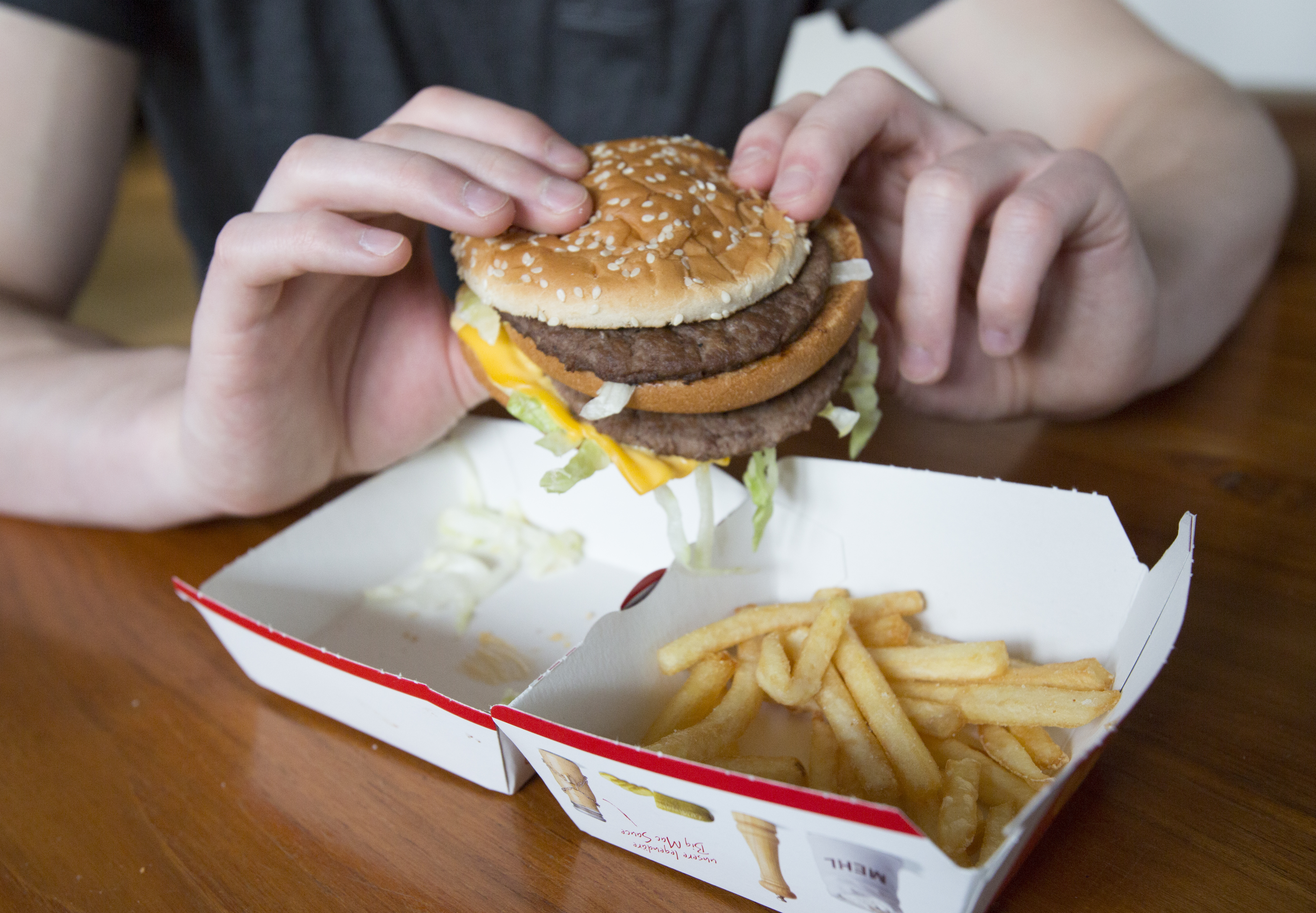 Man holds a Big Mac from McDonald’s.