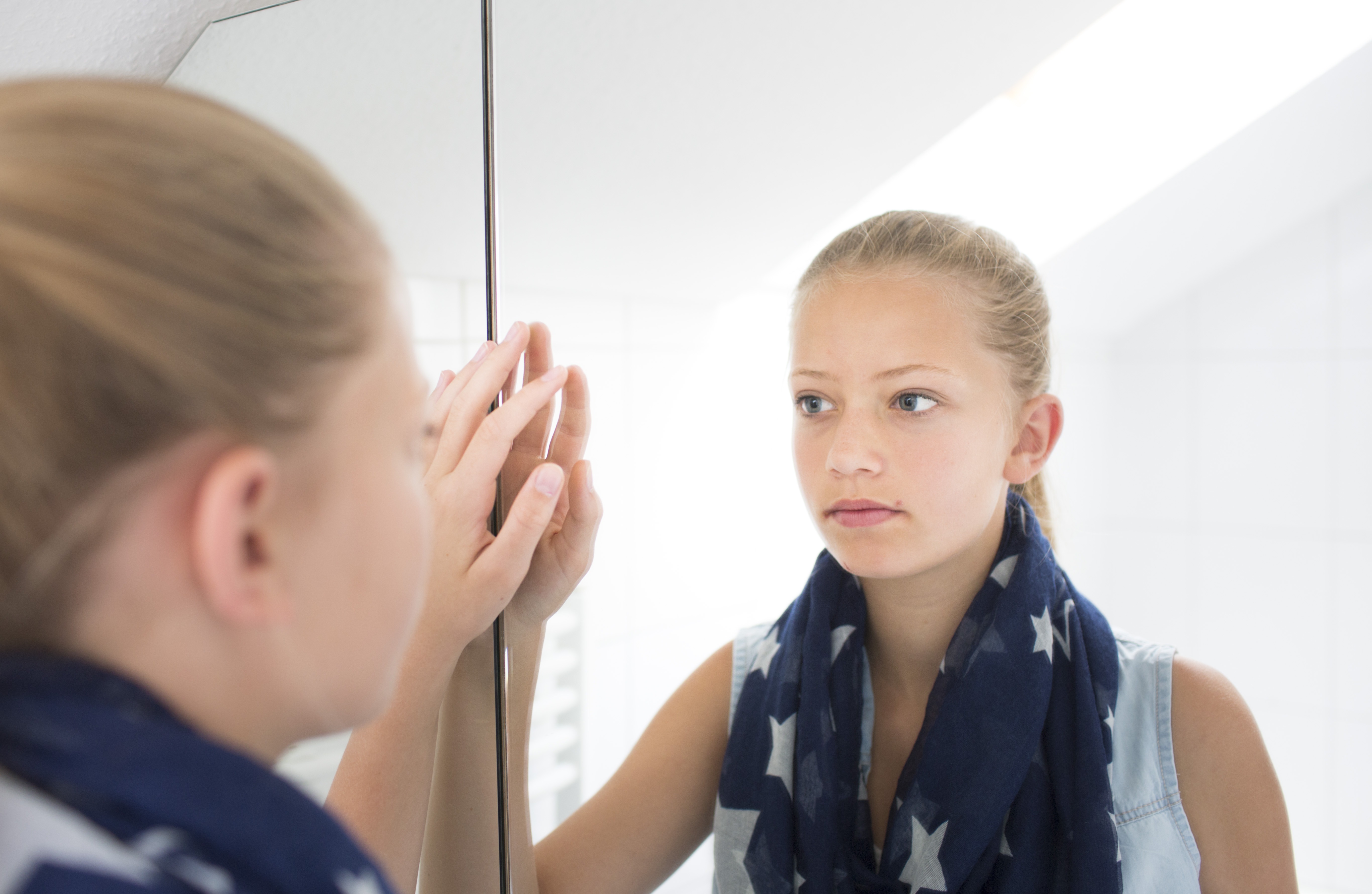 Teenager In Front Of A Mirror