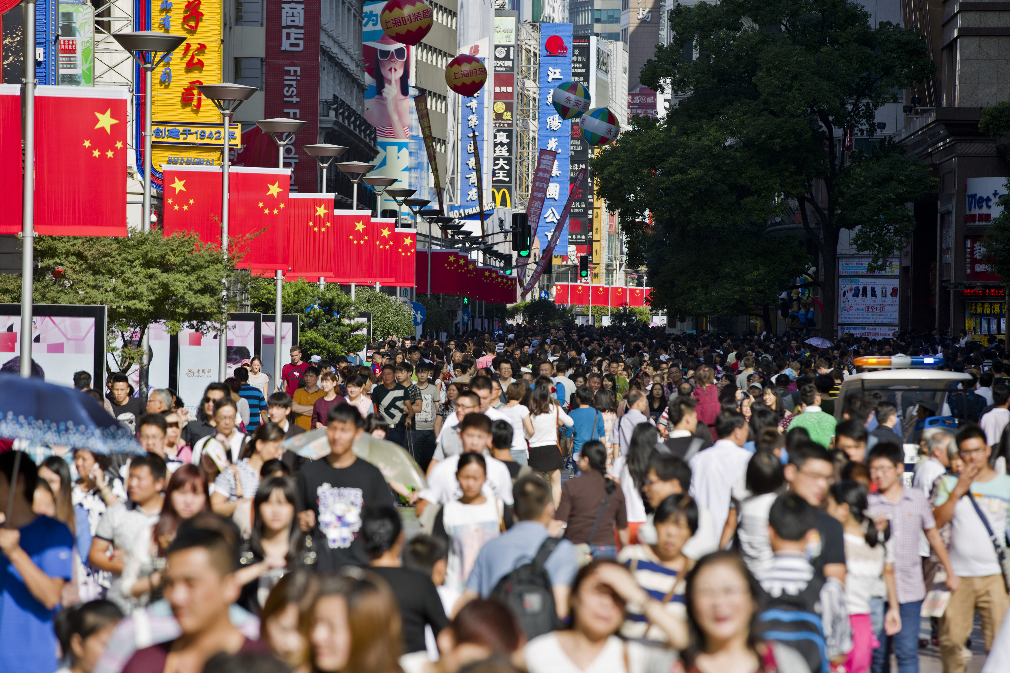 Chinese national flags are seen as tourists crowd along the Nanjing Pedestrian Road, a main shopping area, during national day holidays, in Shanghai
