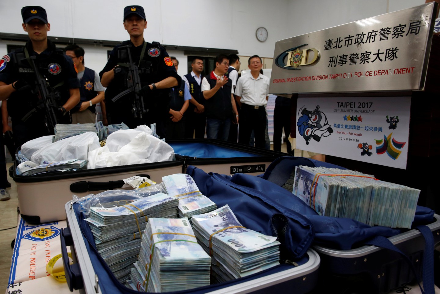 Taiwanese banknotes are displayed after they were found from a hotel room rented by one of the suspects involved in stealing from automated teller machines (ATM) in Taipei