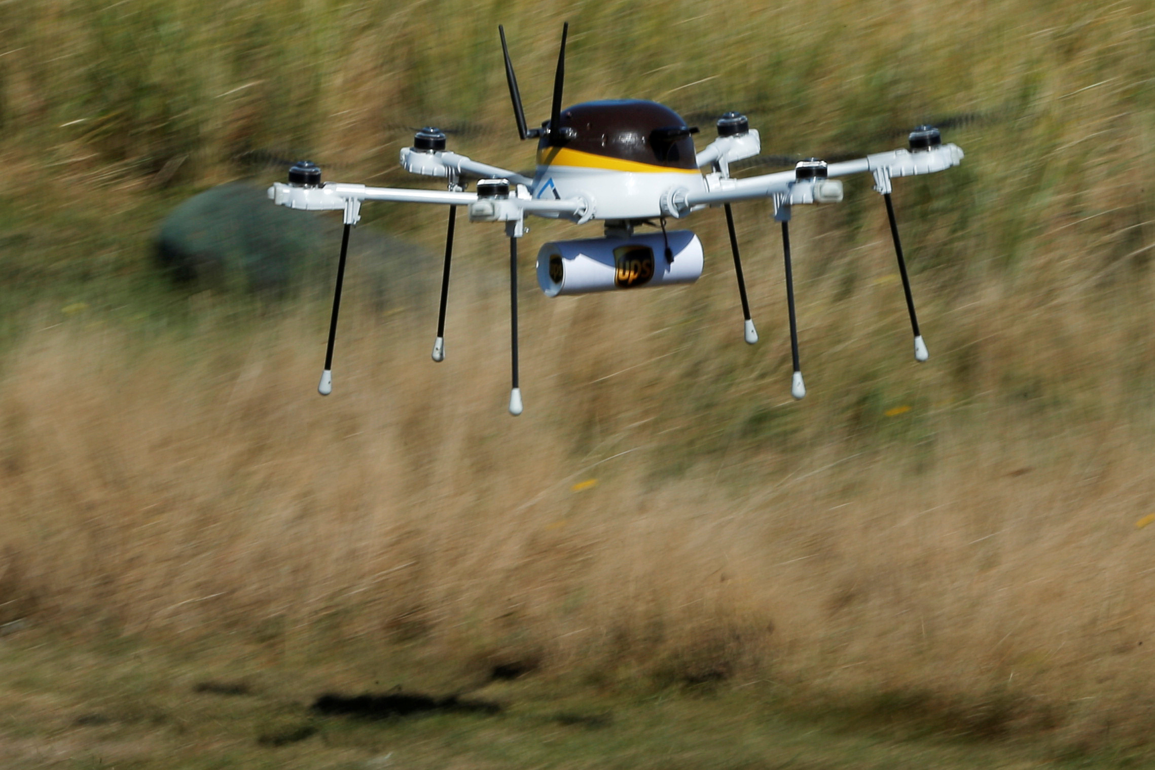 A drone, made by CyPhy Works, carries a UPS package on Children's Island off the coast of Beverly