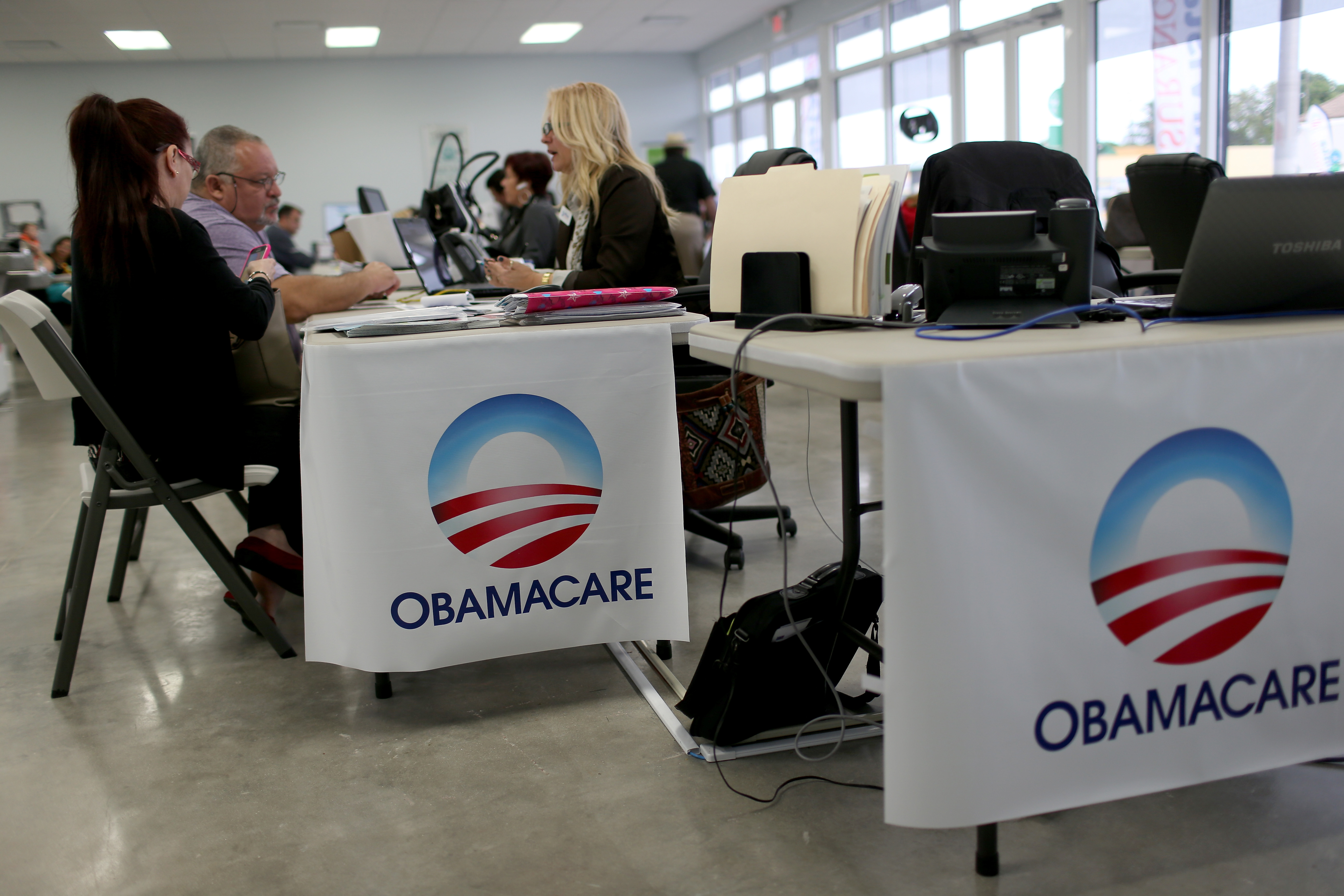 Aymara Marchante (L) and Wiktor Garcia sit with Maria Elena Santa Coloma, as they sign up for the Affordable Care Act, also known as Obamacare, before the February 15th deadline on February 5, 2015 in Miami, Florida.