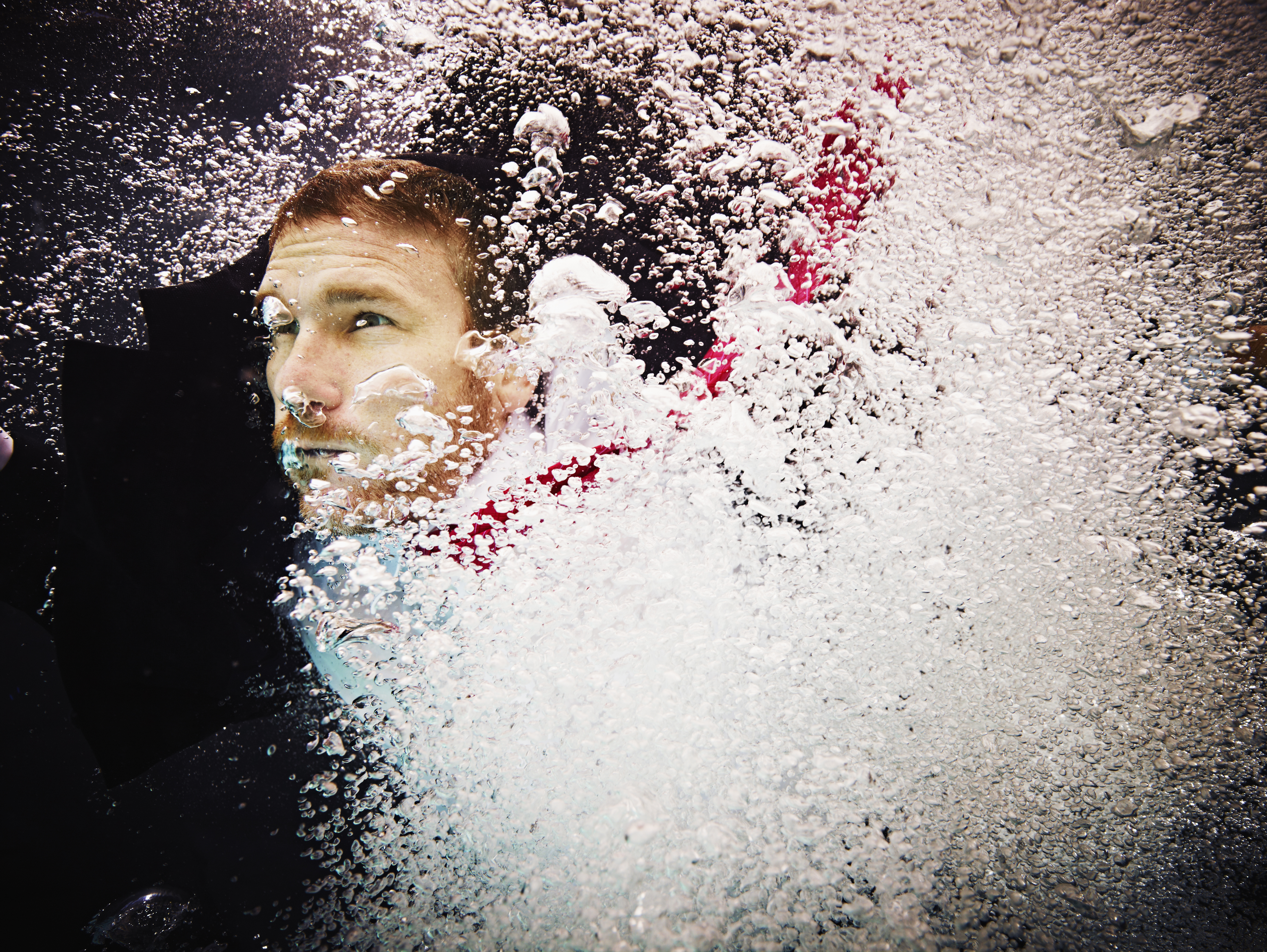 Underwater view of businessman in turbulent water