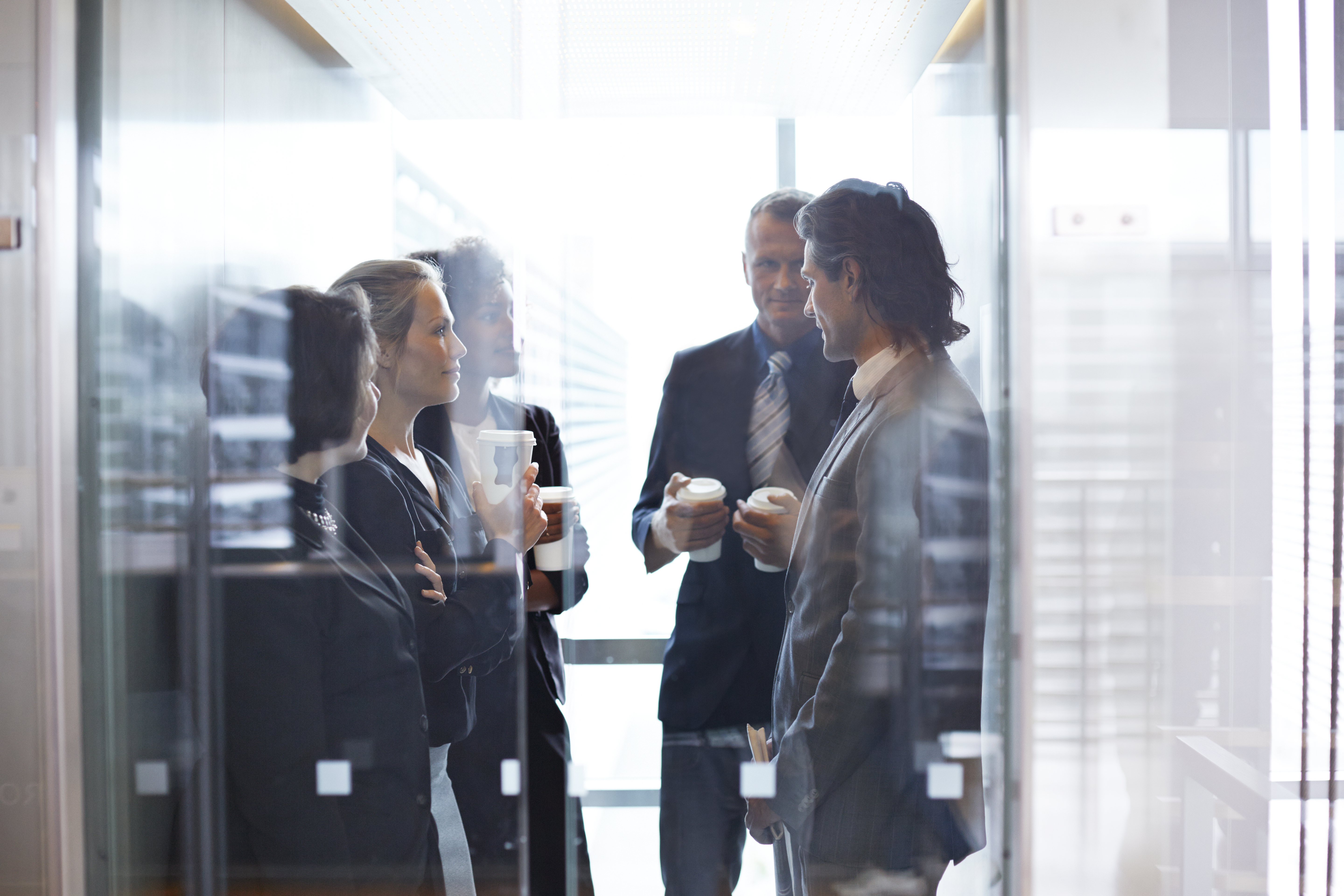 Business people standing together in elevator