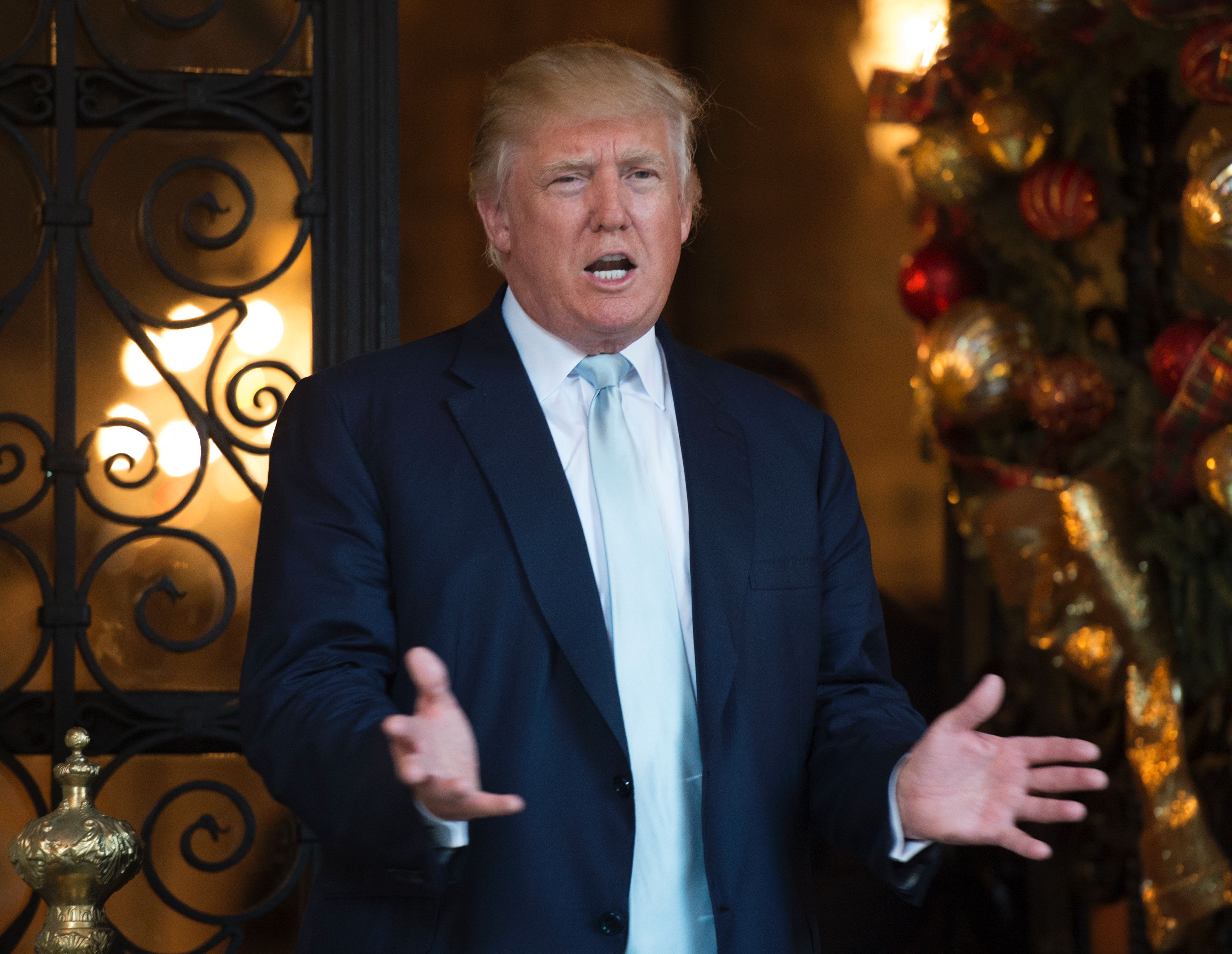 US President-elect Donald Trump answers questions from the media after a day of meetings on December 28, 2016 at Mar-a-Lago in Palm Beach, Florida.