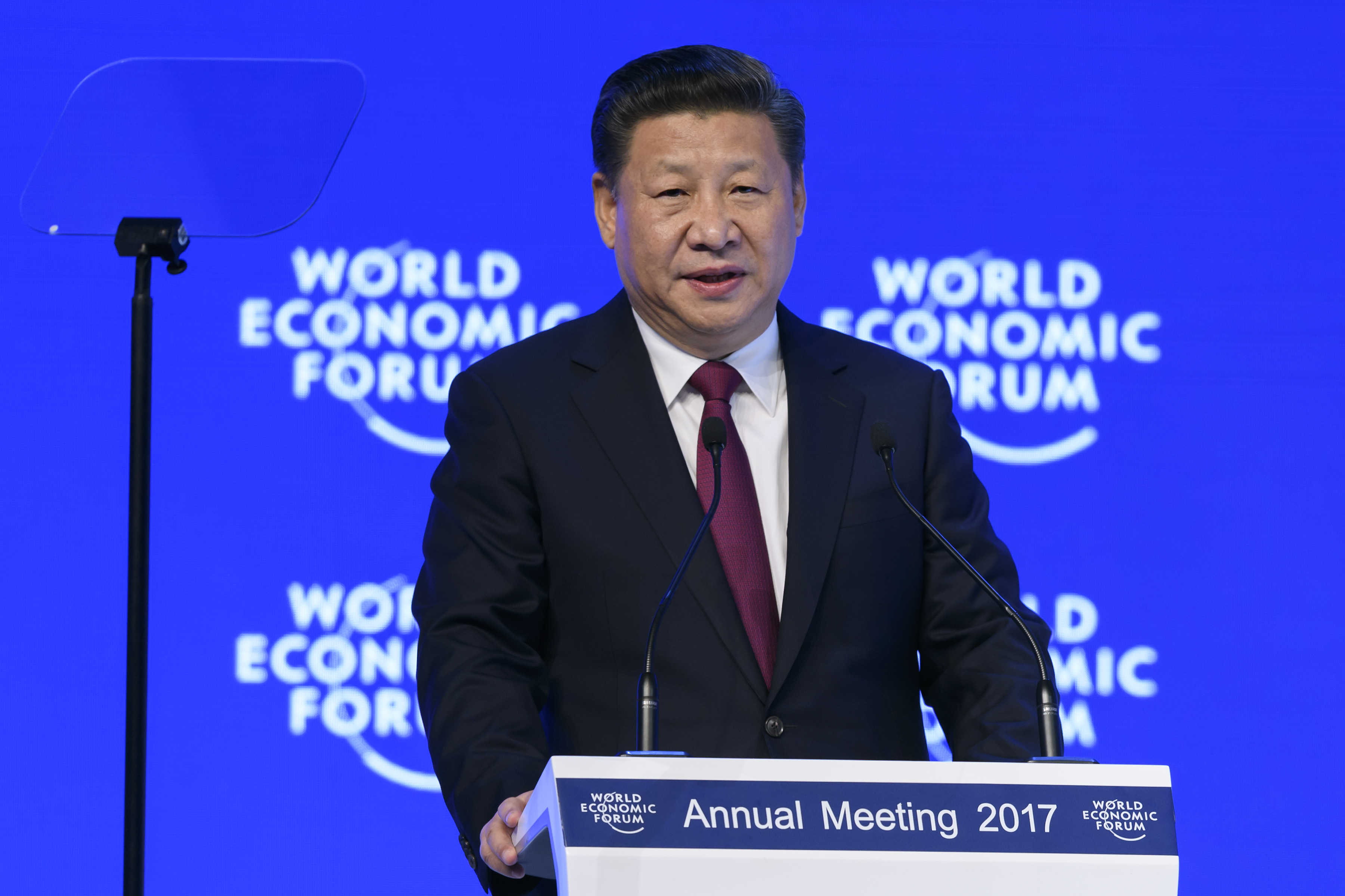 SWITZERLAND-ECONOMY-POLITICS-DIPLOMACY-SUMMITChina's President Xi Jinping delivers a speech during the first day of the World Economic Forum, on January 17, 2017 in Davos. Chinese President Xi Jinping said on January 17, 2017 that there is "no point" in blaming economic globalisation for the world's problems. The leader of the world's second largest economy made the comment at the World Economic Forum, where he is making his first appearance as China seeks to play a greater role in world trade regimes amid rising protectionism in the US and Europe. The global elite begin a week of earnest debate and Alpine partying in the Swiss ski resort of Davos, in a week bookended by two presidential speeches of historic import. / AFP / FABRICE COFFRINI (Photo credit should read FABRICE COFFRINI/AFP/Getty Images)