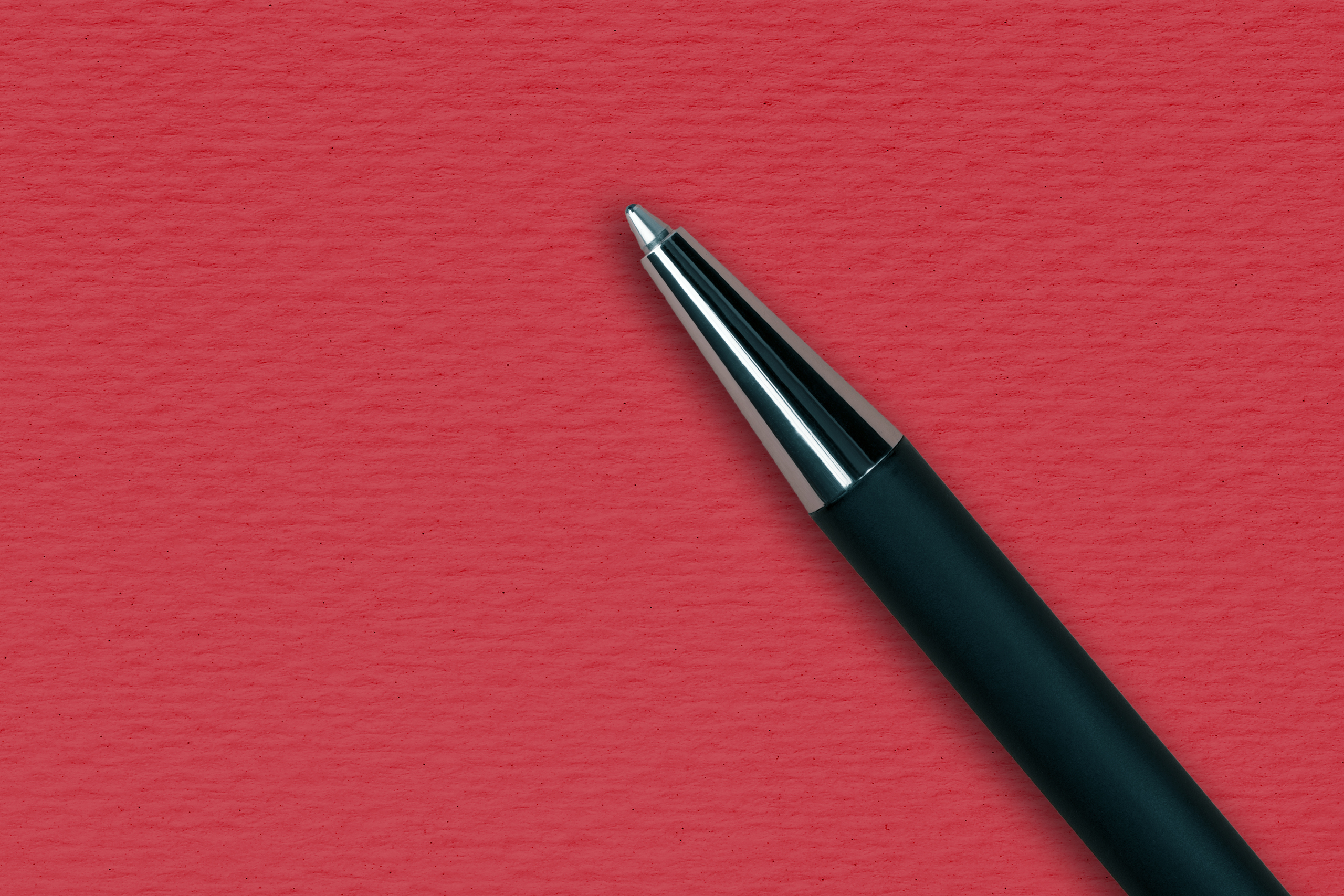 Black ball pen on the red papper background