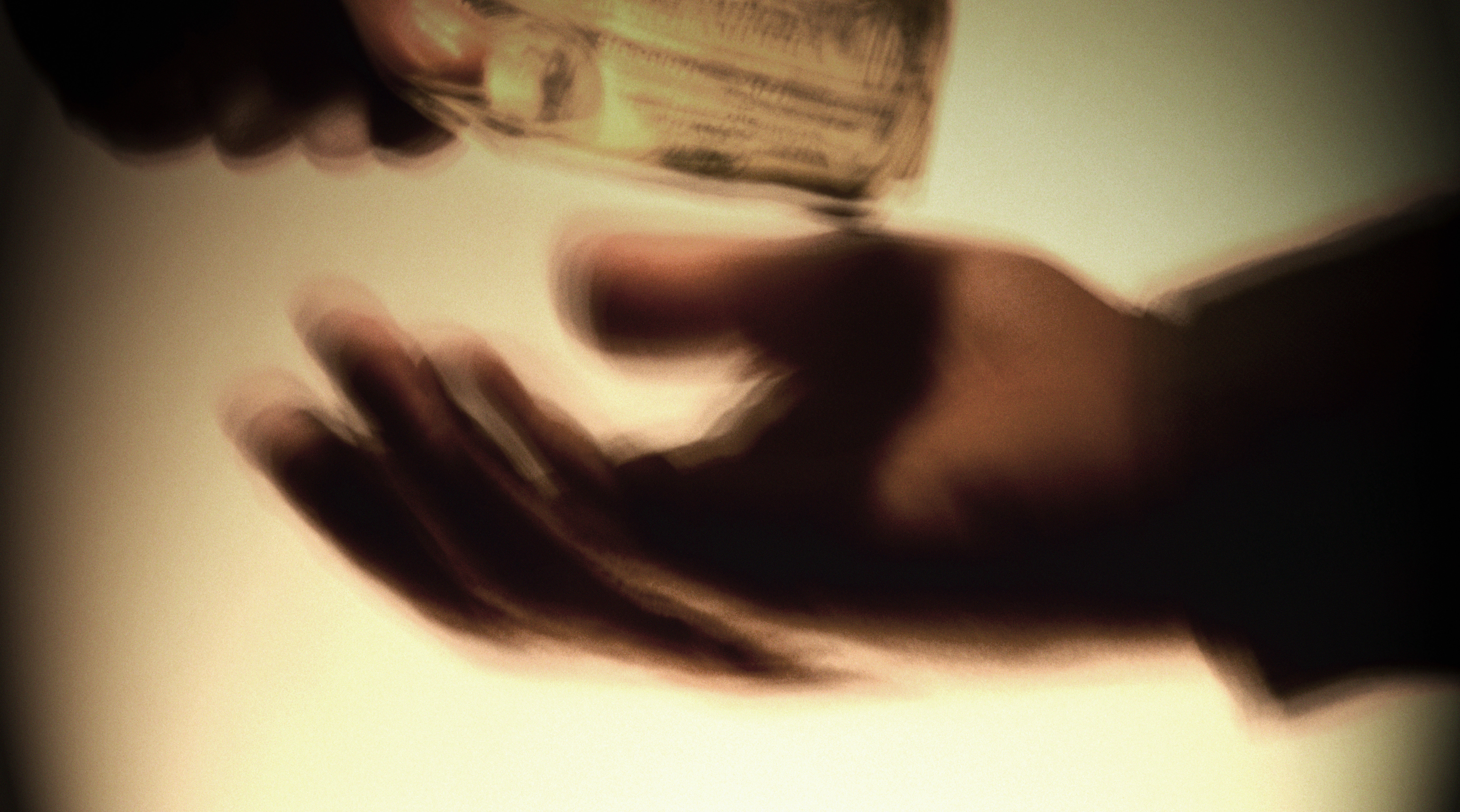 Two men exchanging money, close-up (digital enhancement)