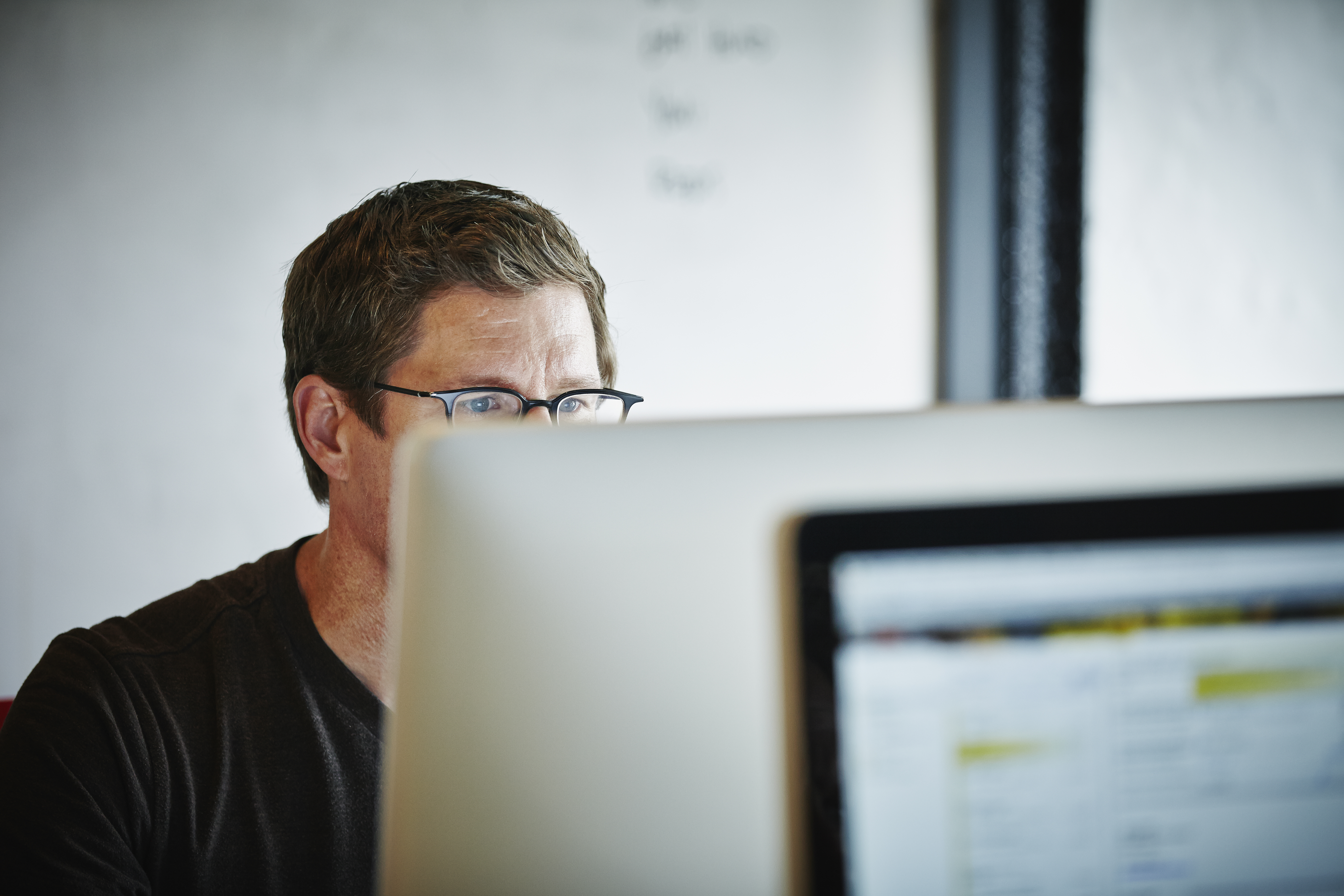 Businessman sitting at desk working on computer