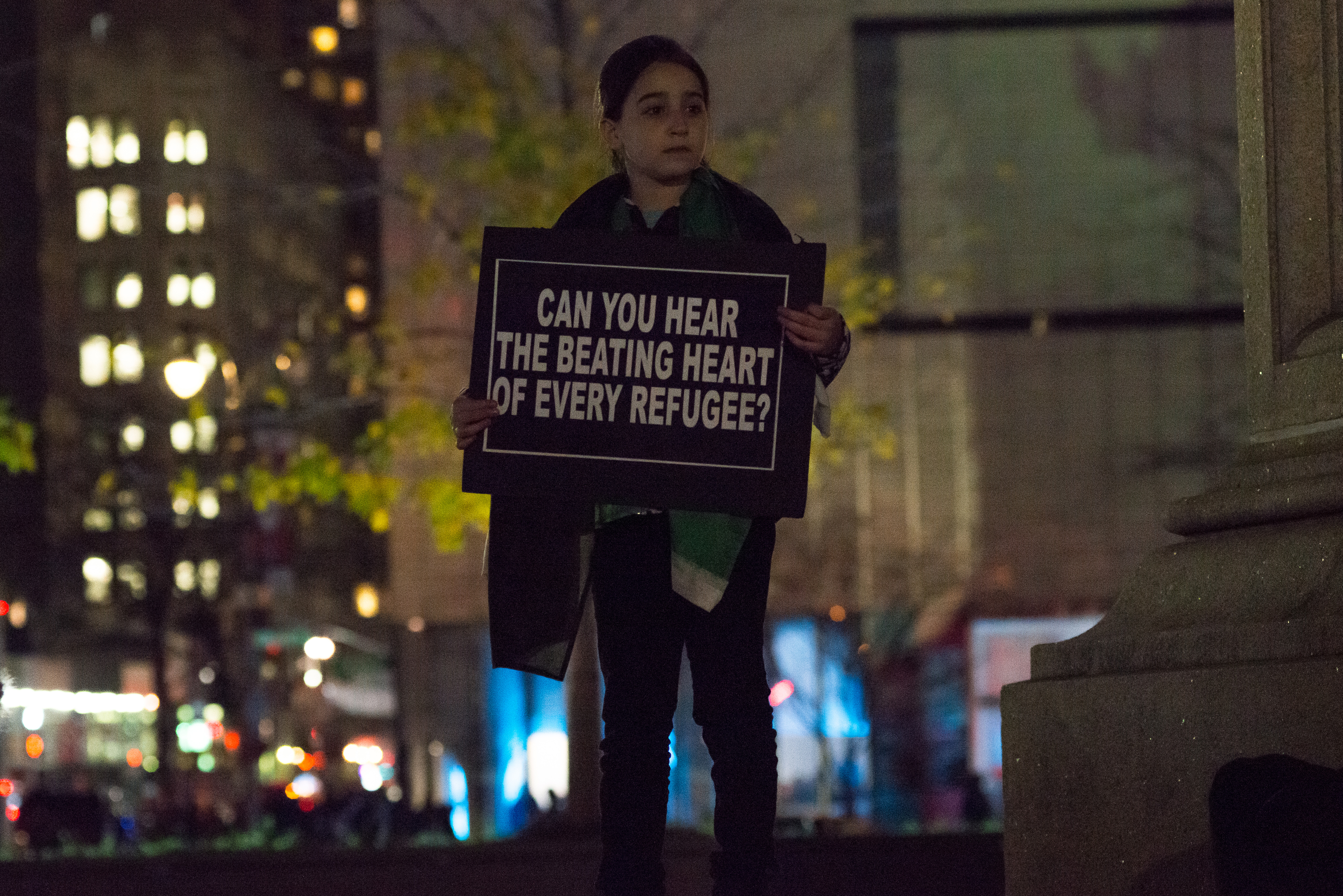 Demonstrators hold aloft signs at the rally against Donald